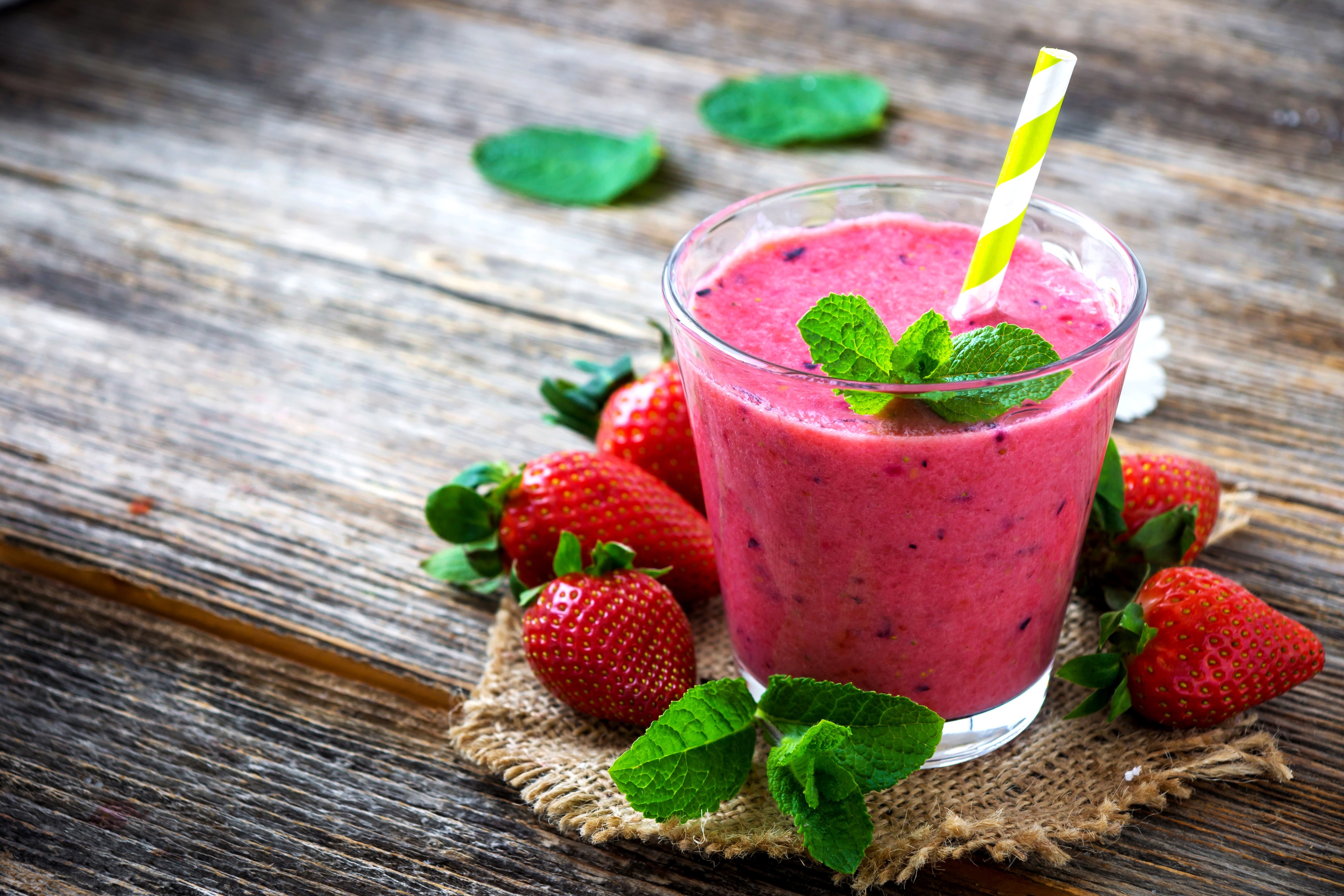 Strawberry smoothie with mint and strawberries on wooden table HD Wallpaper