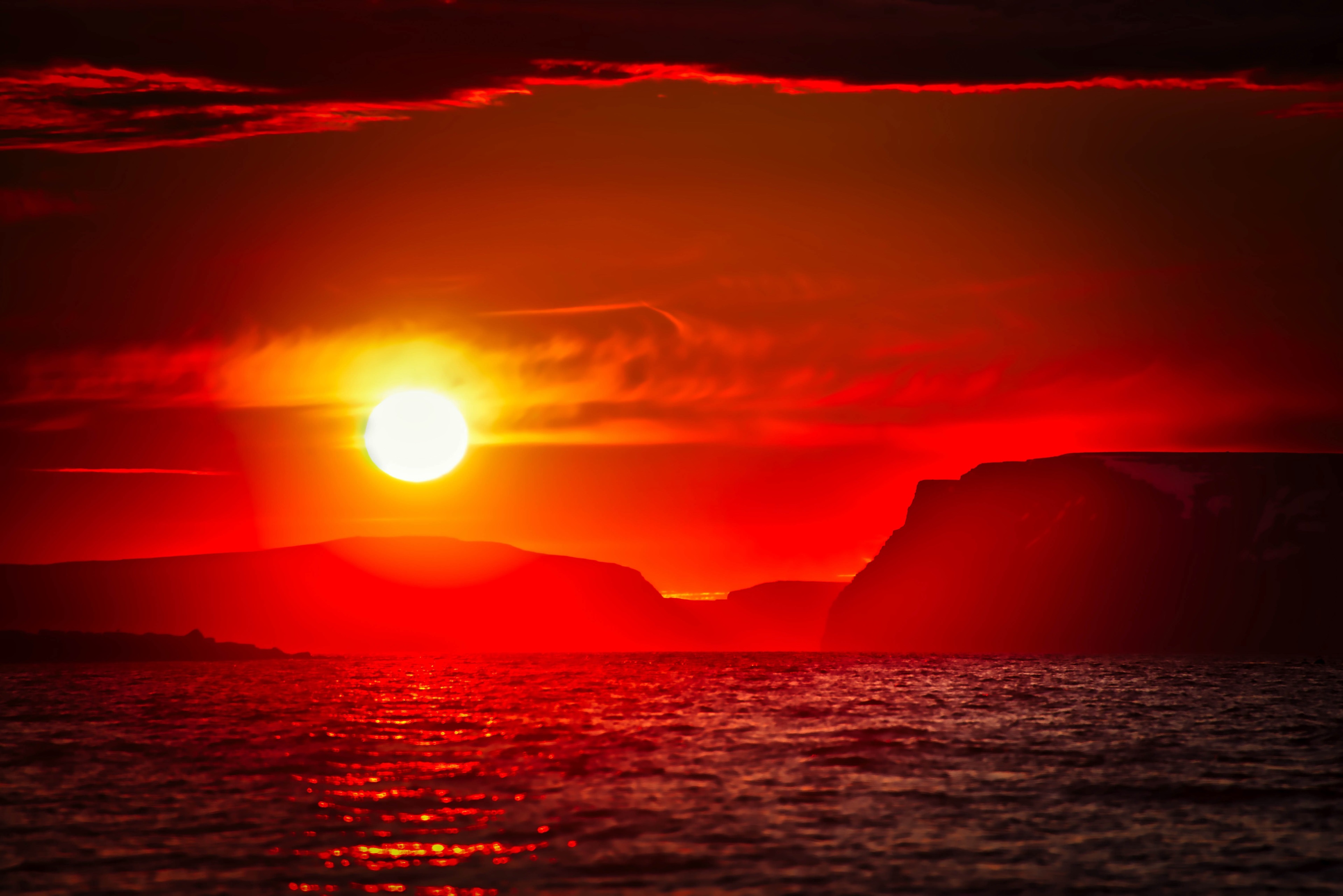 Sunset over the ocean with cliffs HD Wallpaper