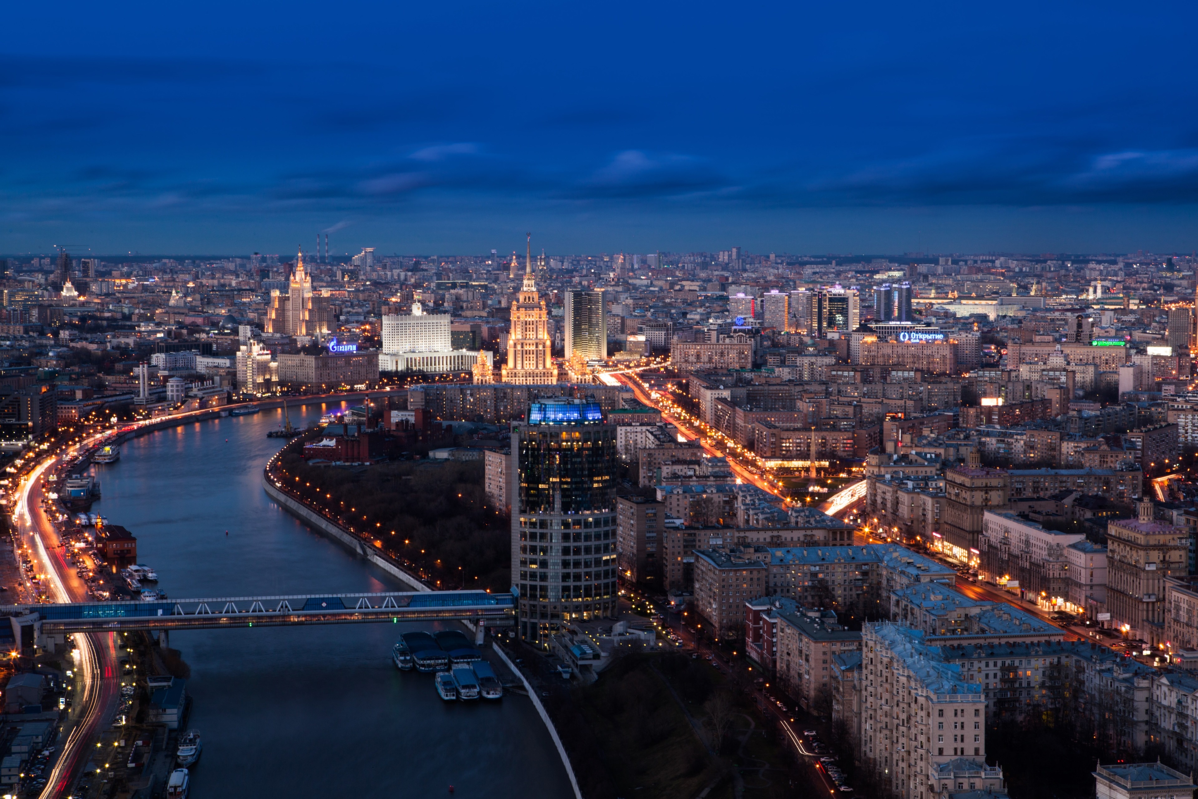 Moscow cityscape with river and illuminated buildings at dusk HD Wallpaper