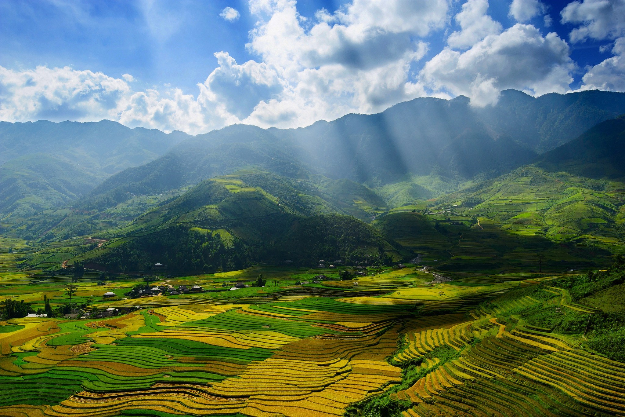 Terraced fields in a mountain valley with sun rays HD Wallpaper