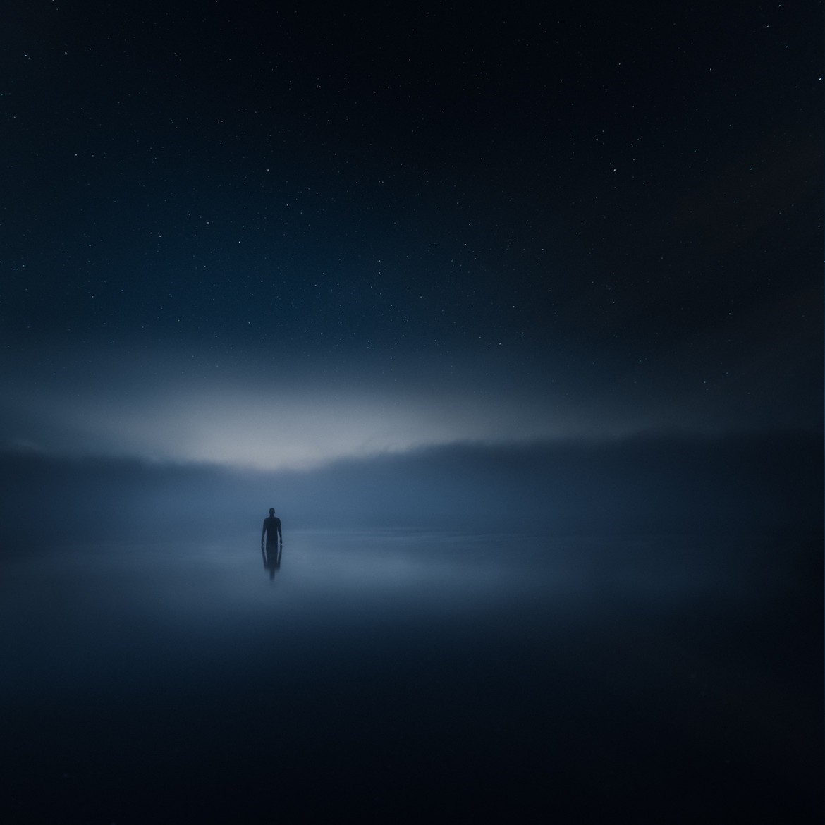 Man standing in water under starry night sky with mist HD Wallpaper