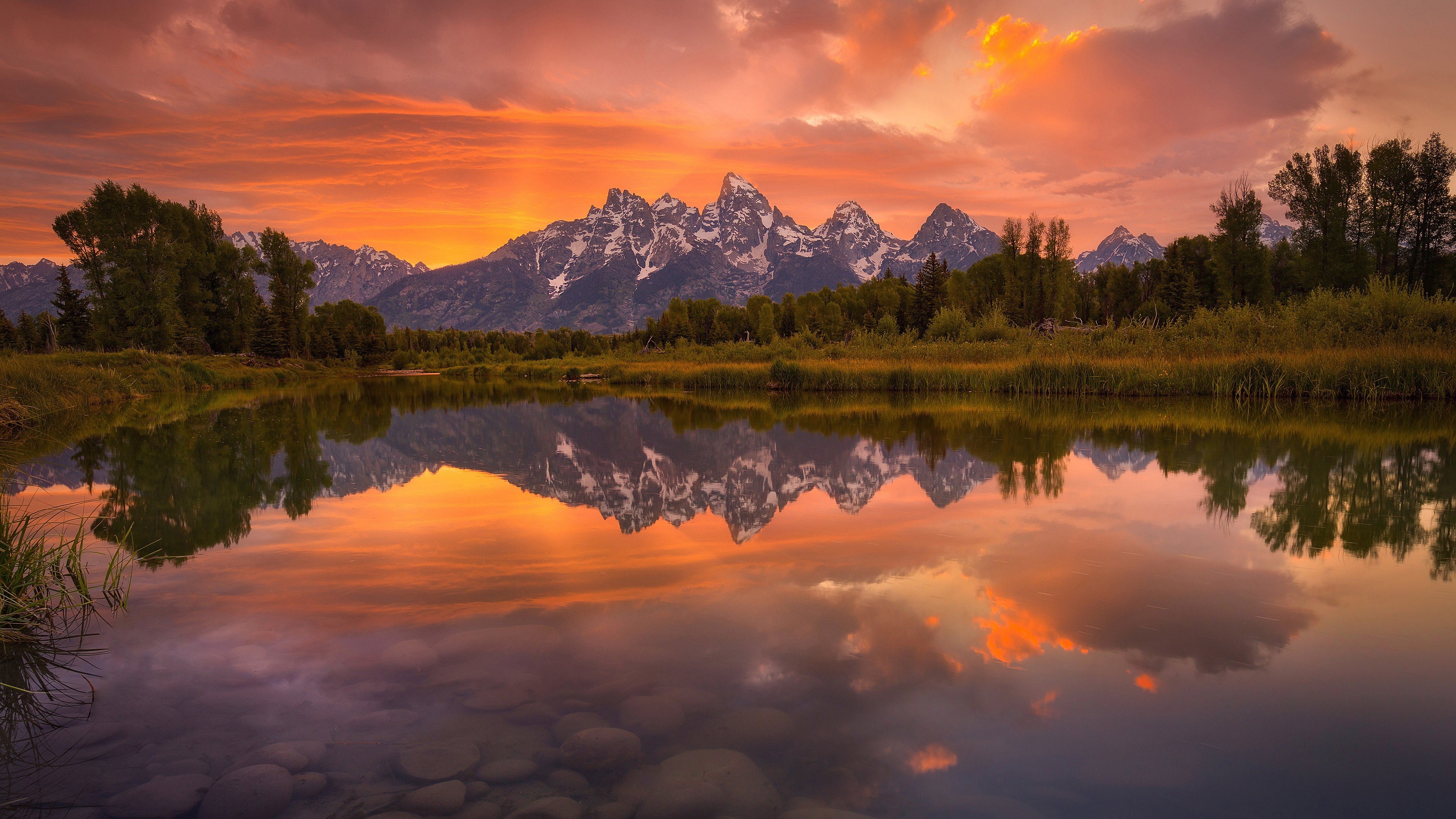 Sunset reflection of snowy mountains over a calm lake HD Wallpaper