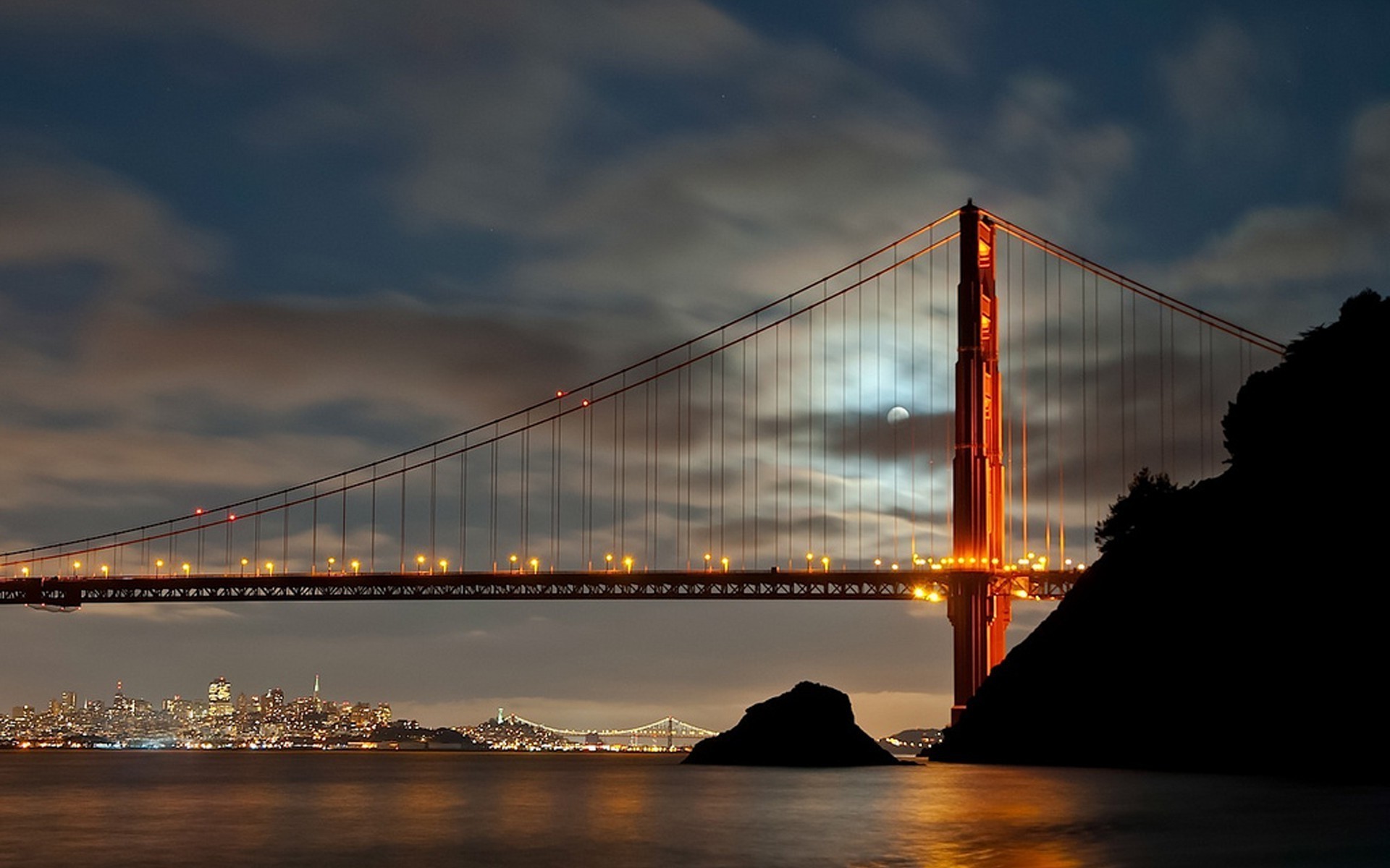 Golden Gate Bridge at night with moon and San Francisco skyline HD Wallpaper