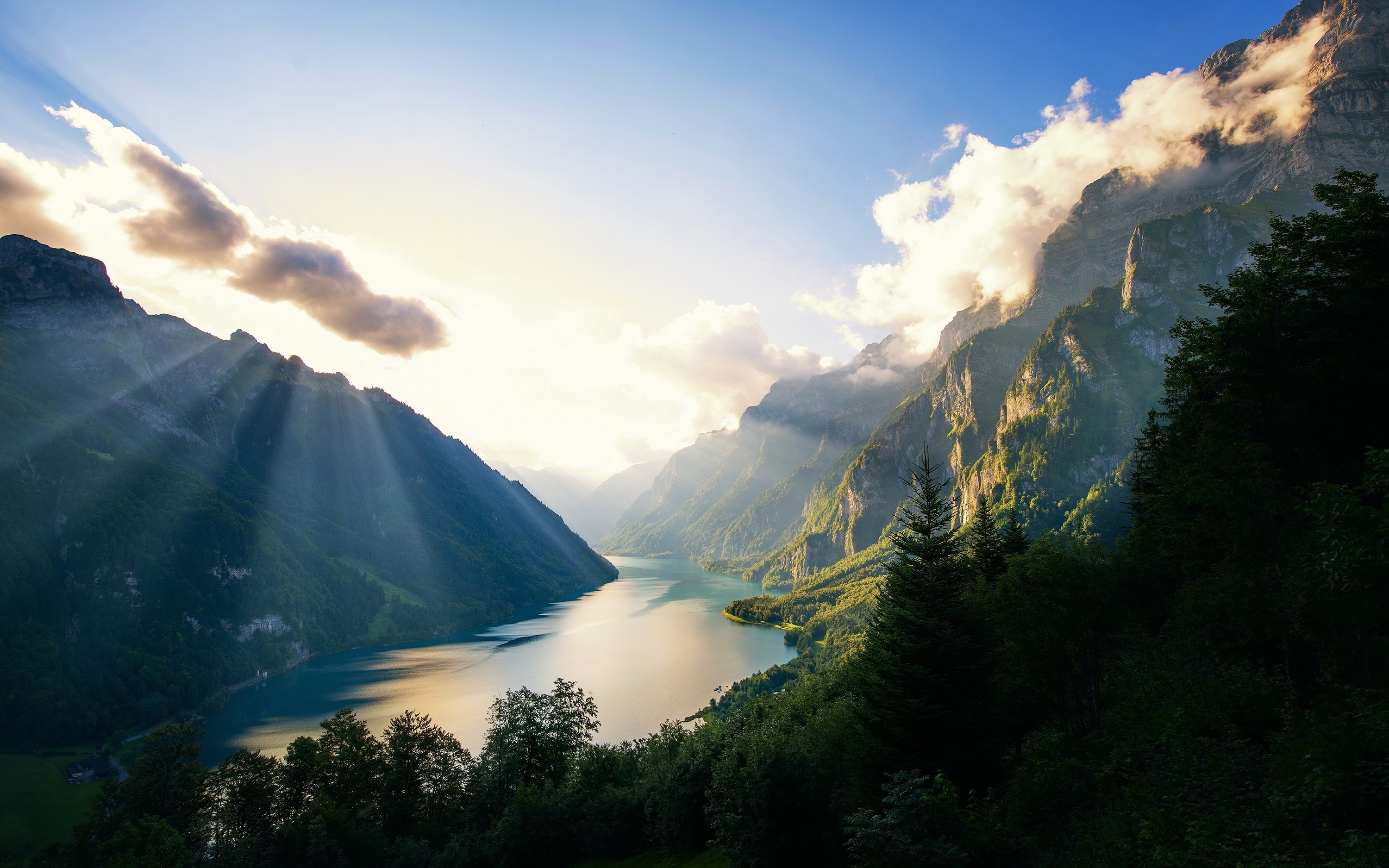 Sun rays over a lake in the Alps at sunset HD Wallpaper