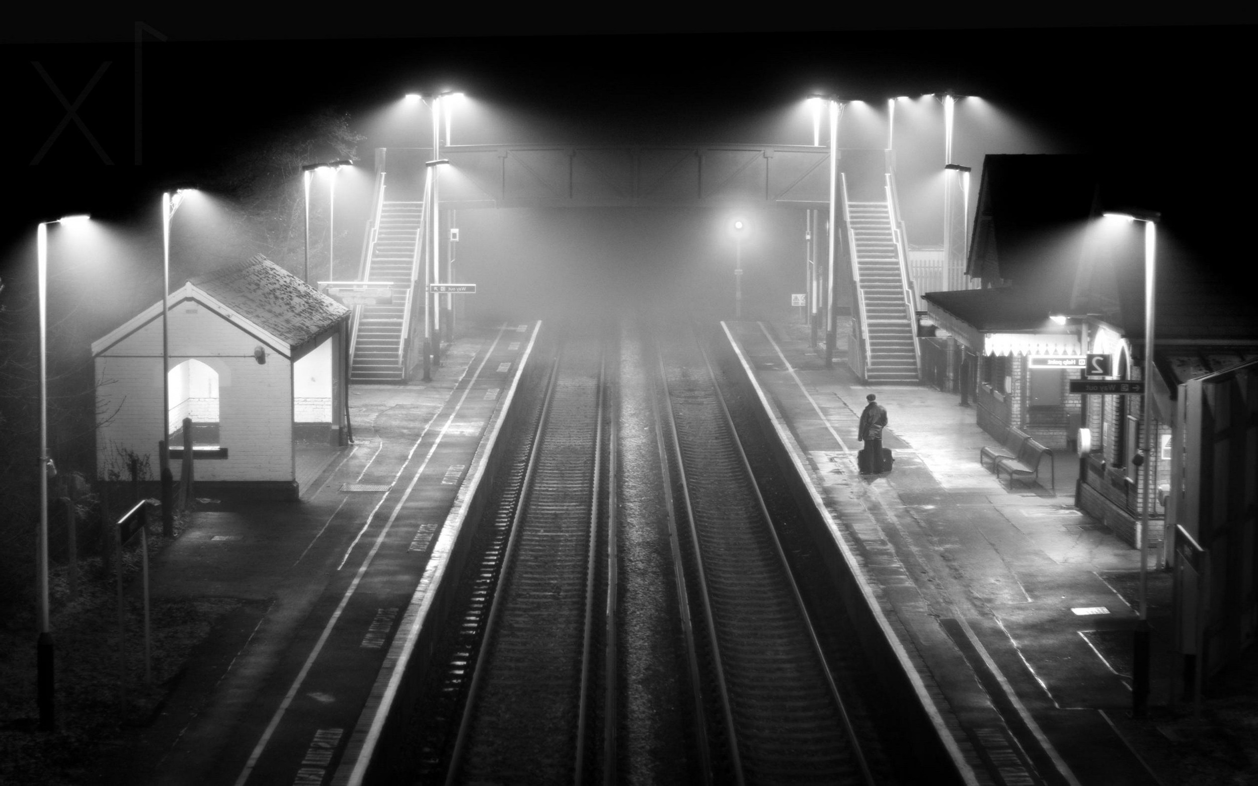 Monochrome train station at night with mist and lights HD Wallpaper