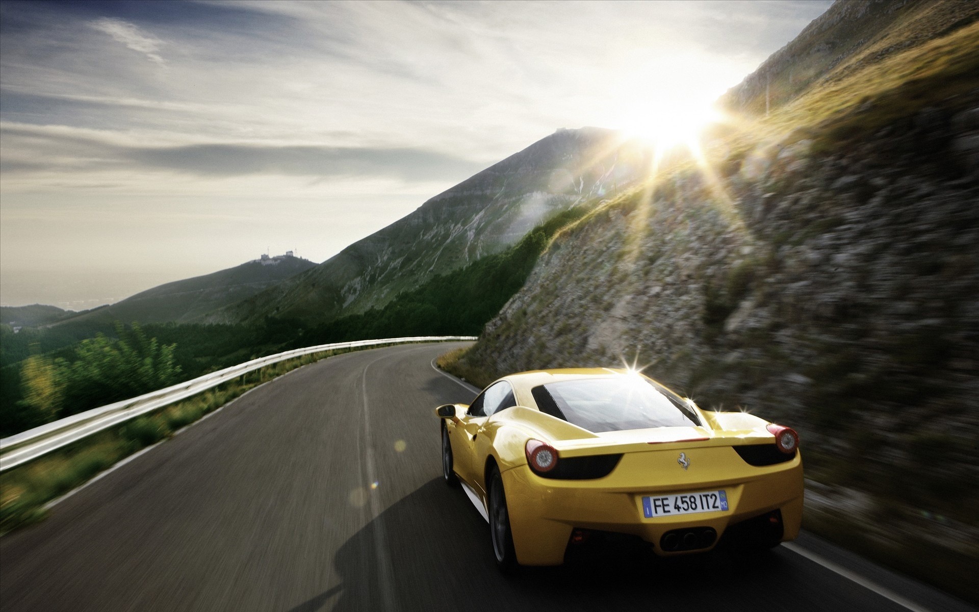 Yellow Ferrari 458 driving on a mountain road HD Wallpaper