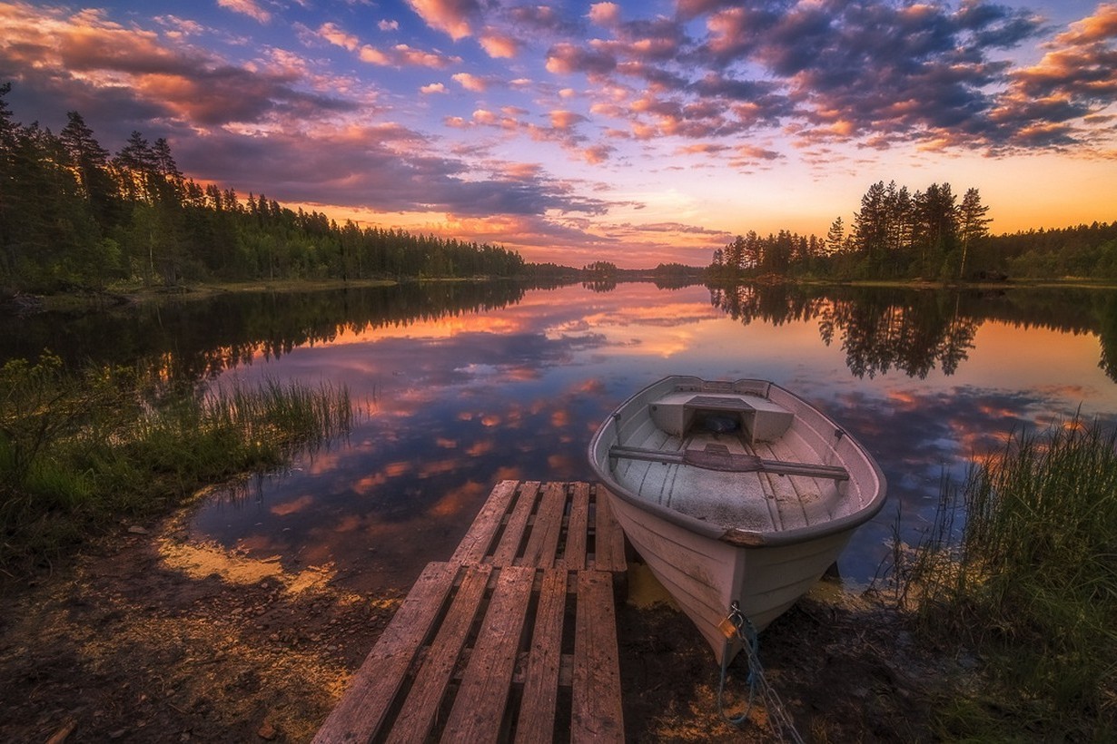 Sunset over a lake with a boat and a dock HD Wallpaper