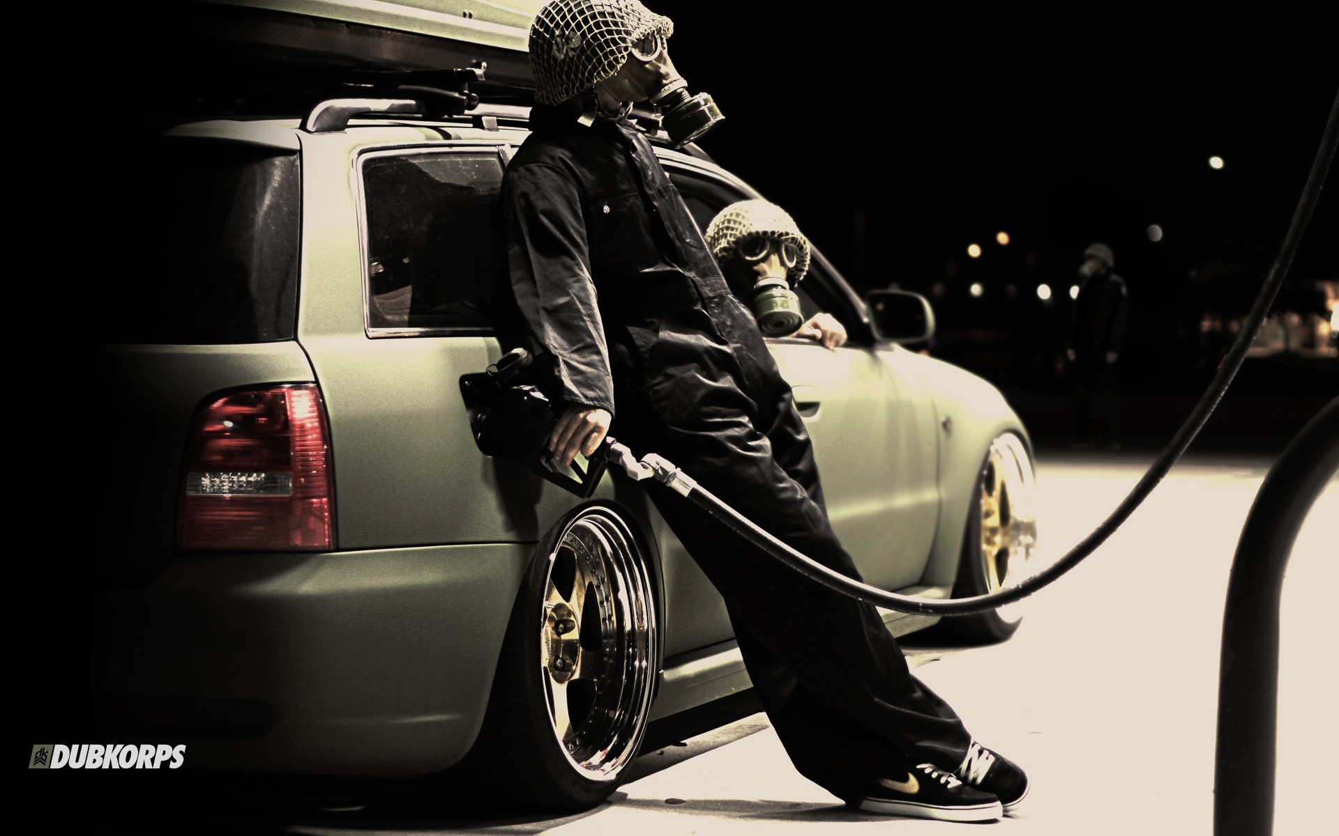 Audi A4 with people in gas masks at a gas station HD Wallpaper