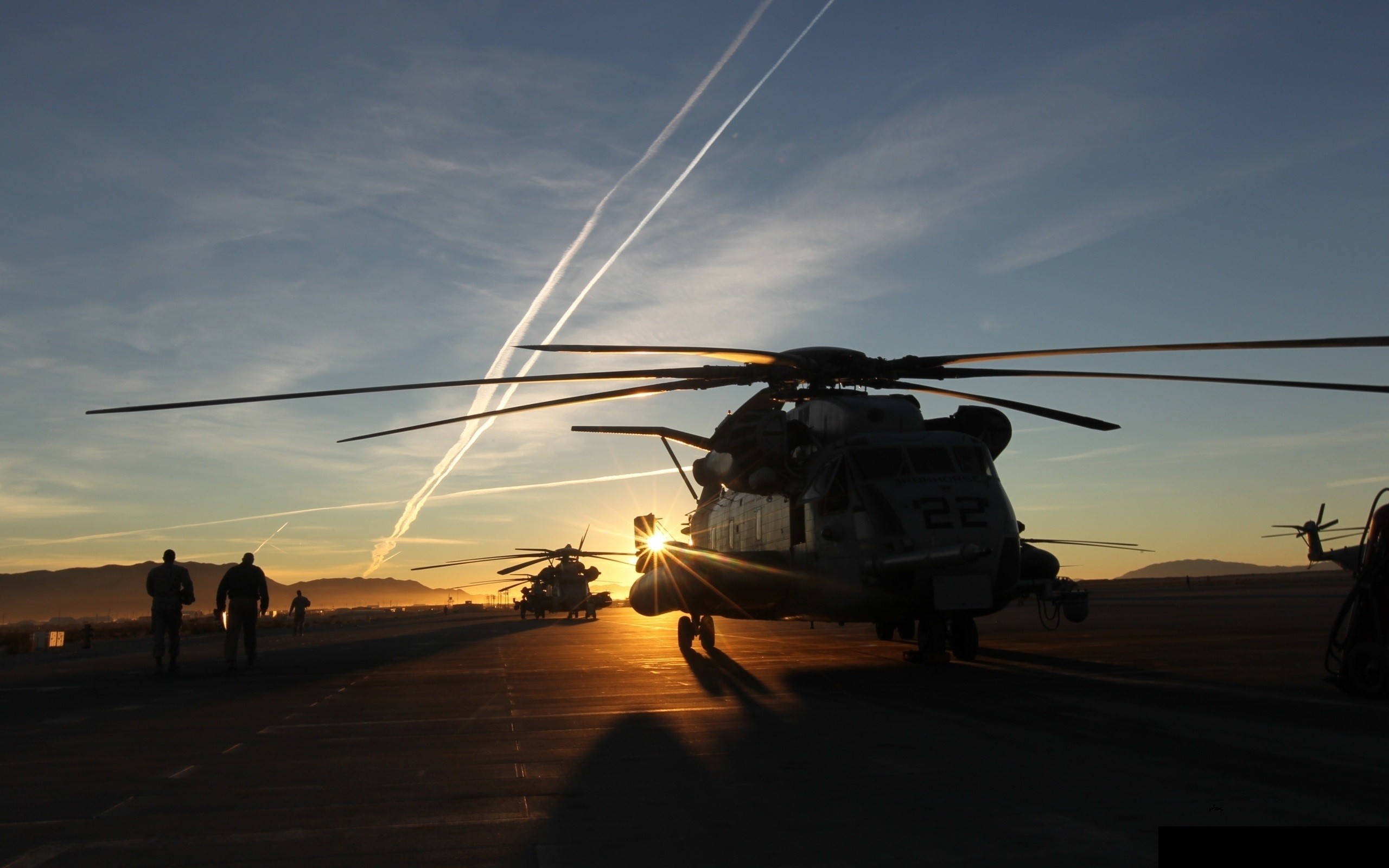 MH-53 Pave Low helicopters on tarmac at sunset HD Wallpaper