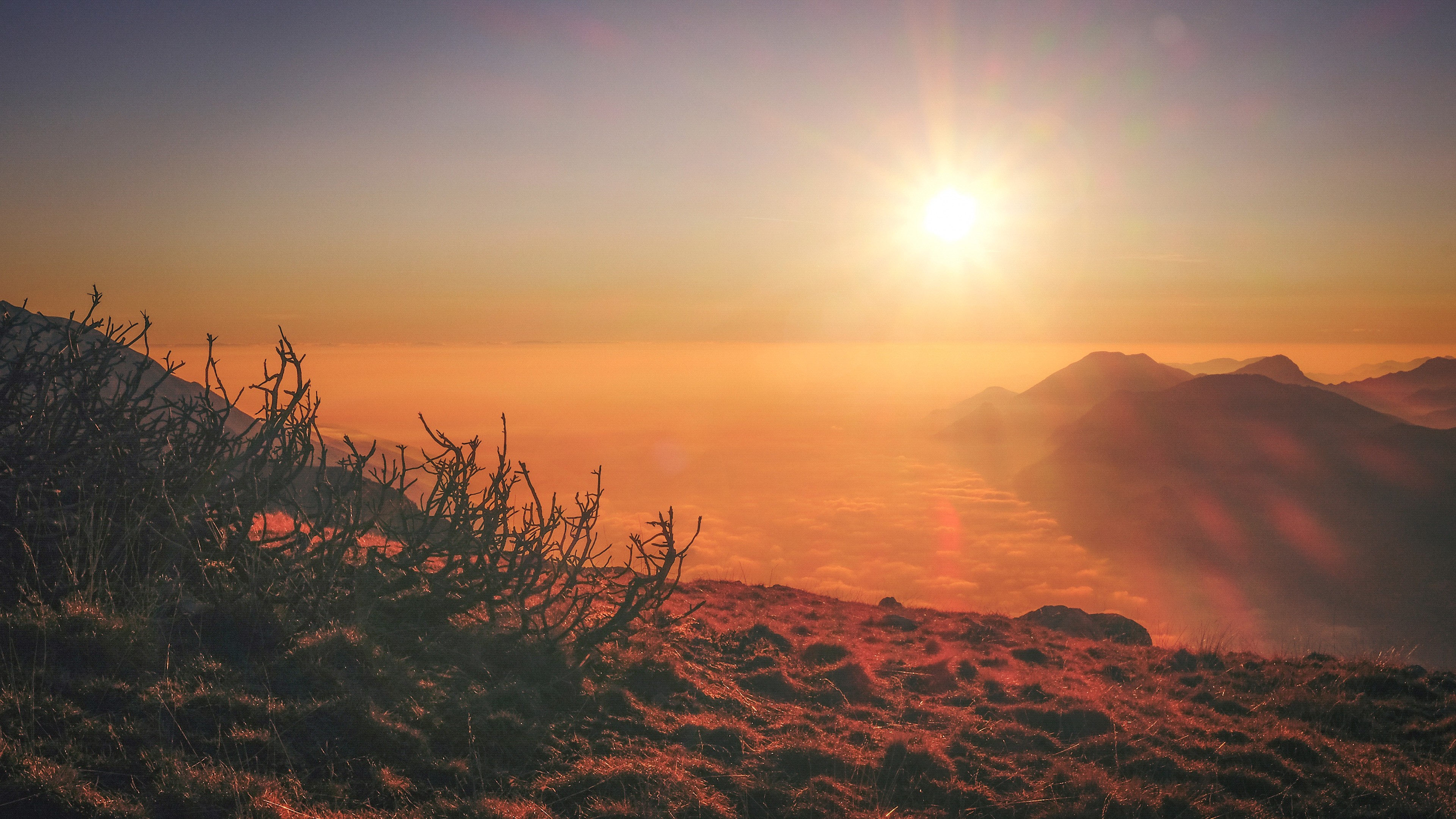 Sunset over mountains with lens flare HD Wallpaper