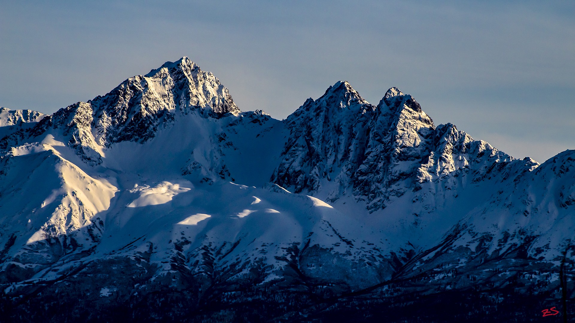 Snow-covered mountains under a clear sky HD Wallpaper