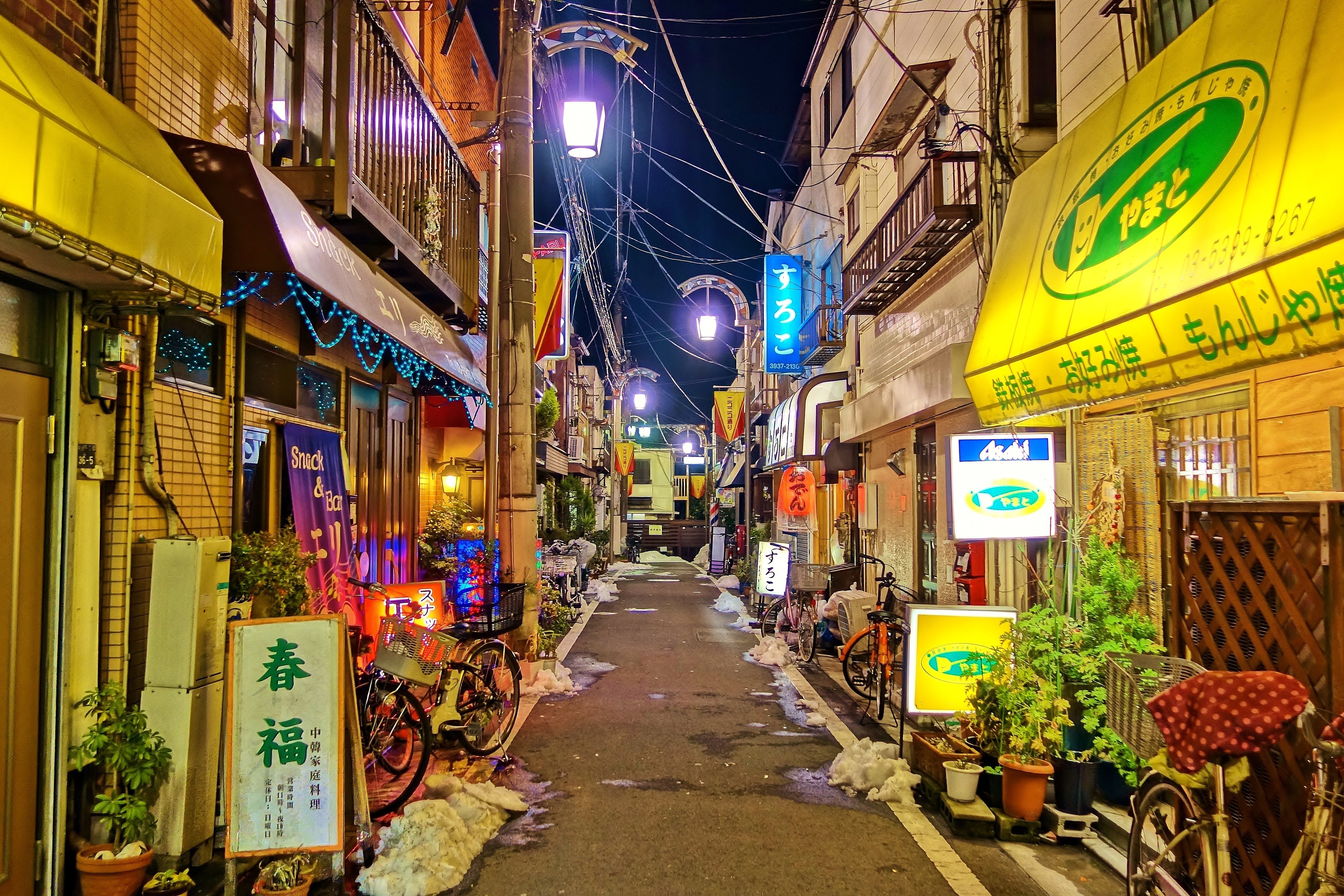 Japanese street at night with illuminated signs and snow HD Wallpaper