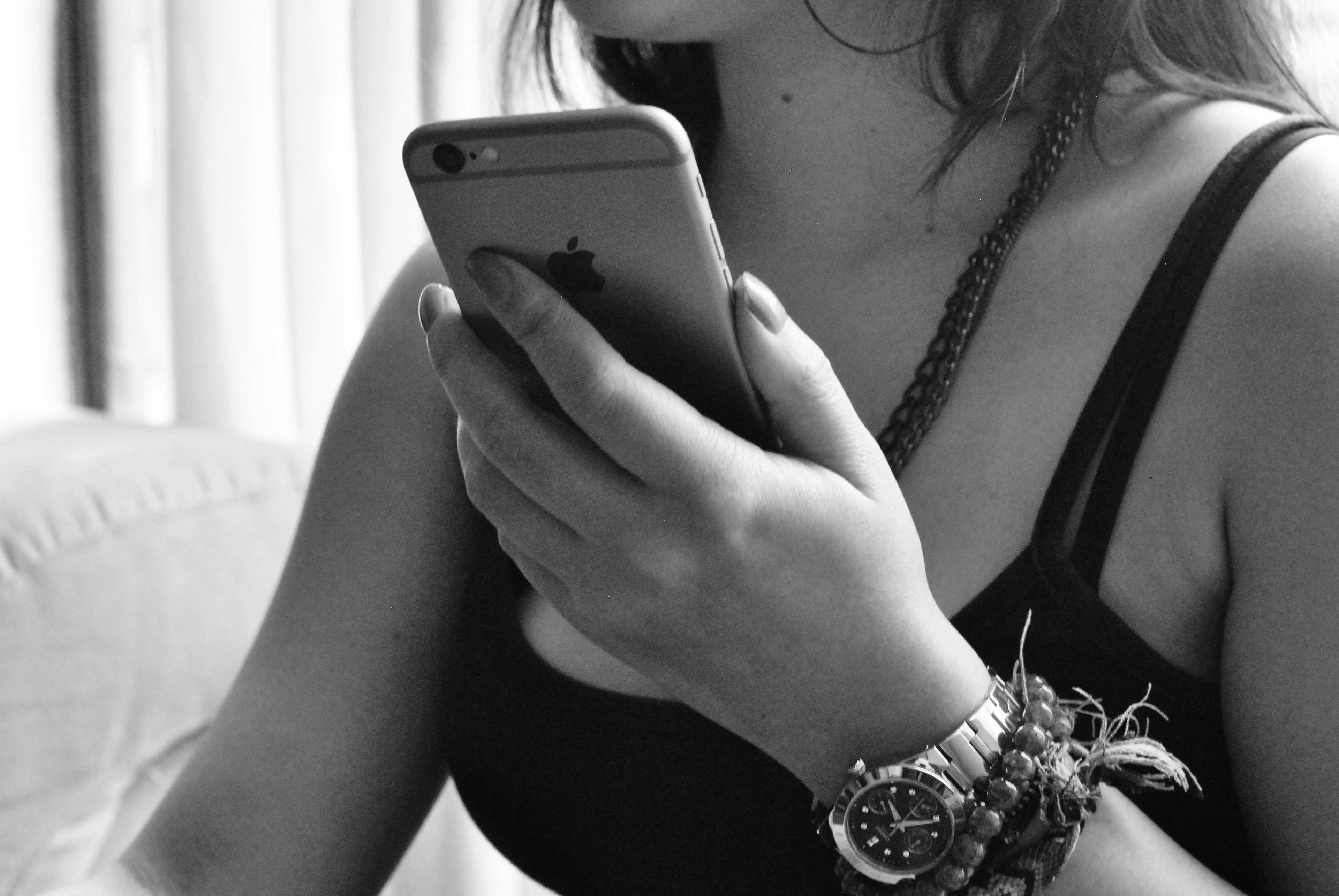 Woman holding an iPhone with a watch HD Wallpaper