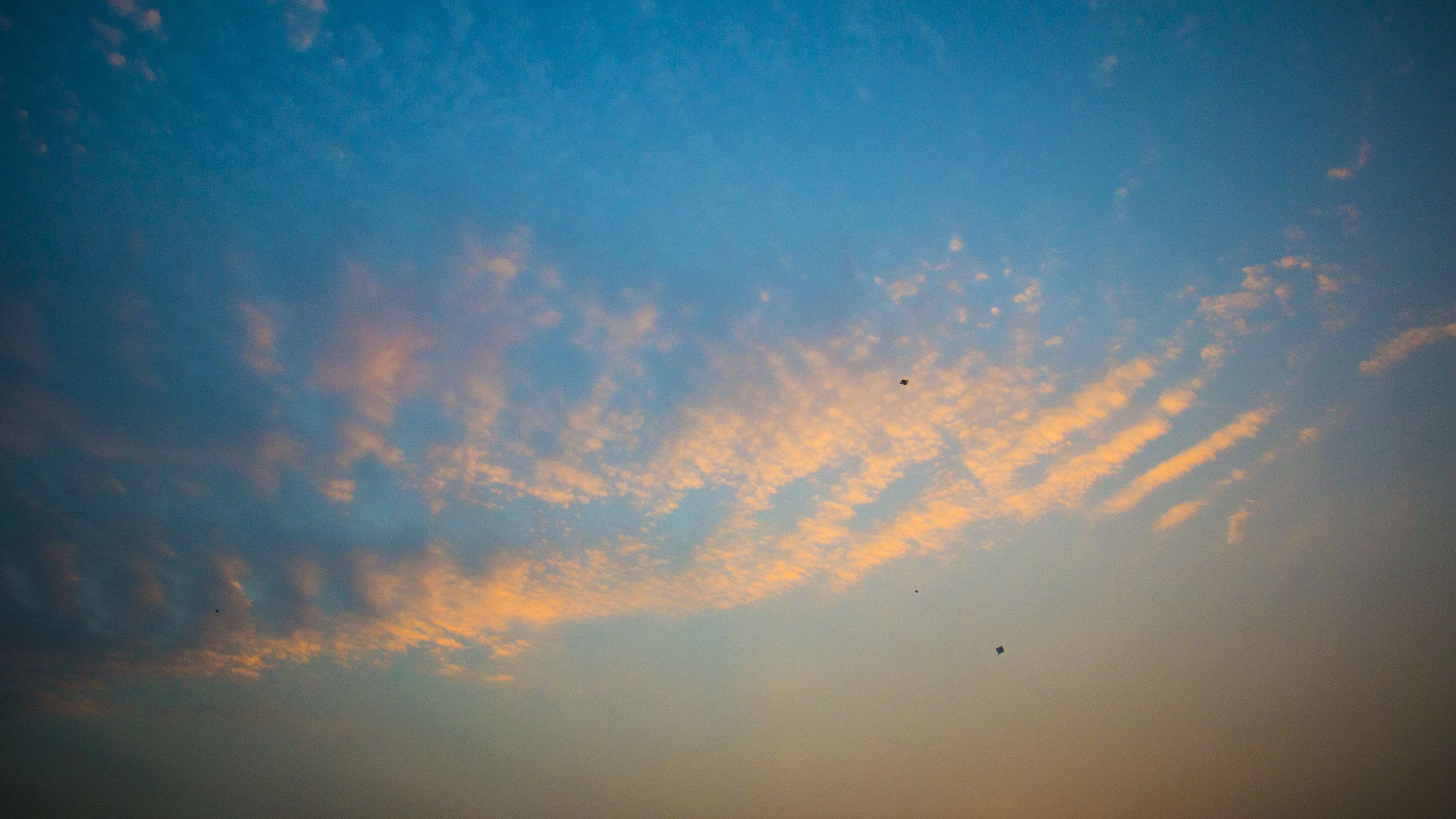 Blue sky with orange clouds and kites HD Wallpaper
