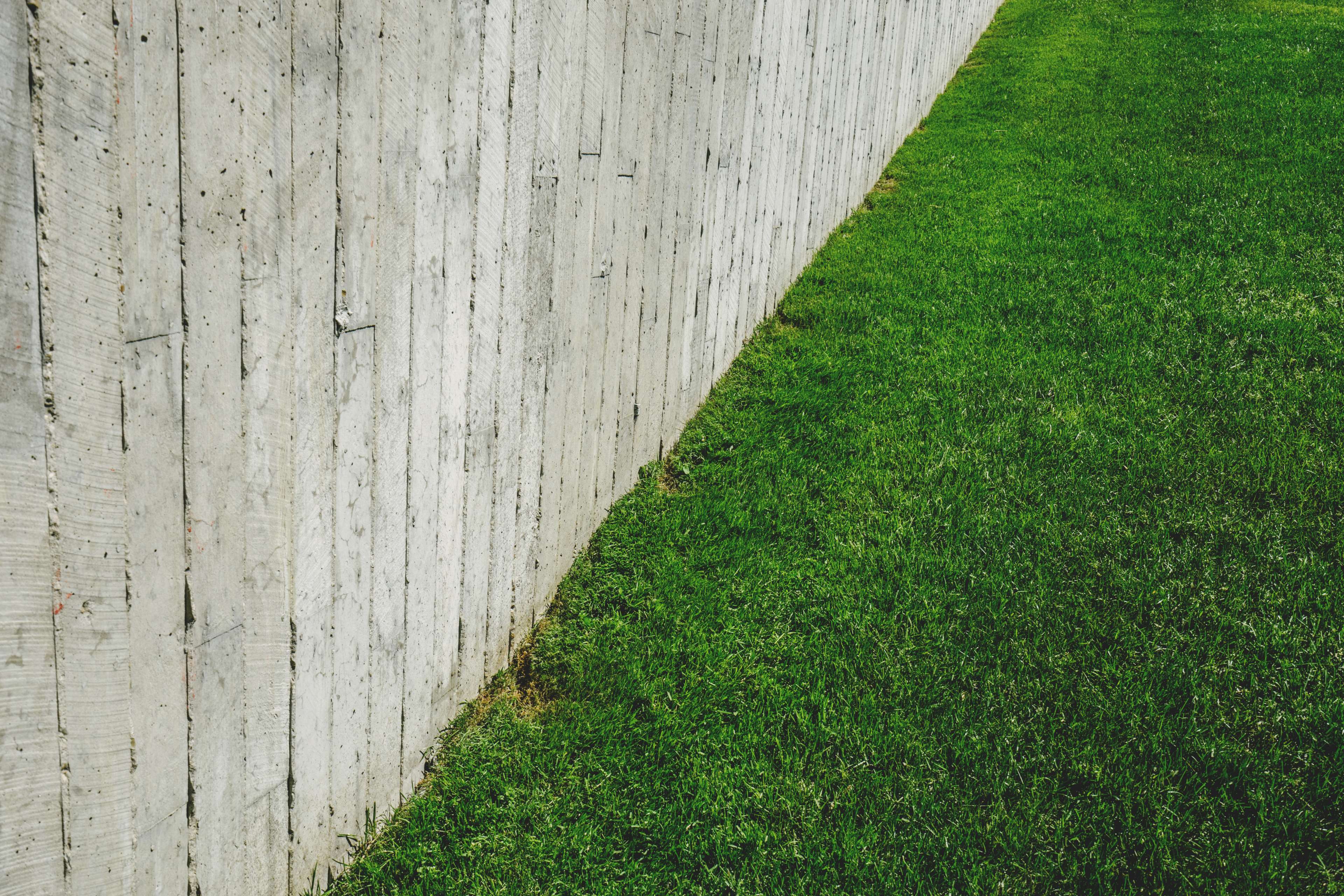 Concrete wall and green grass lawn HD Wallpaper