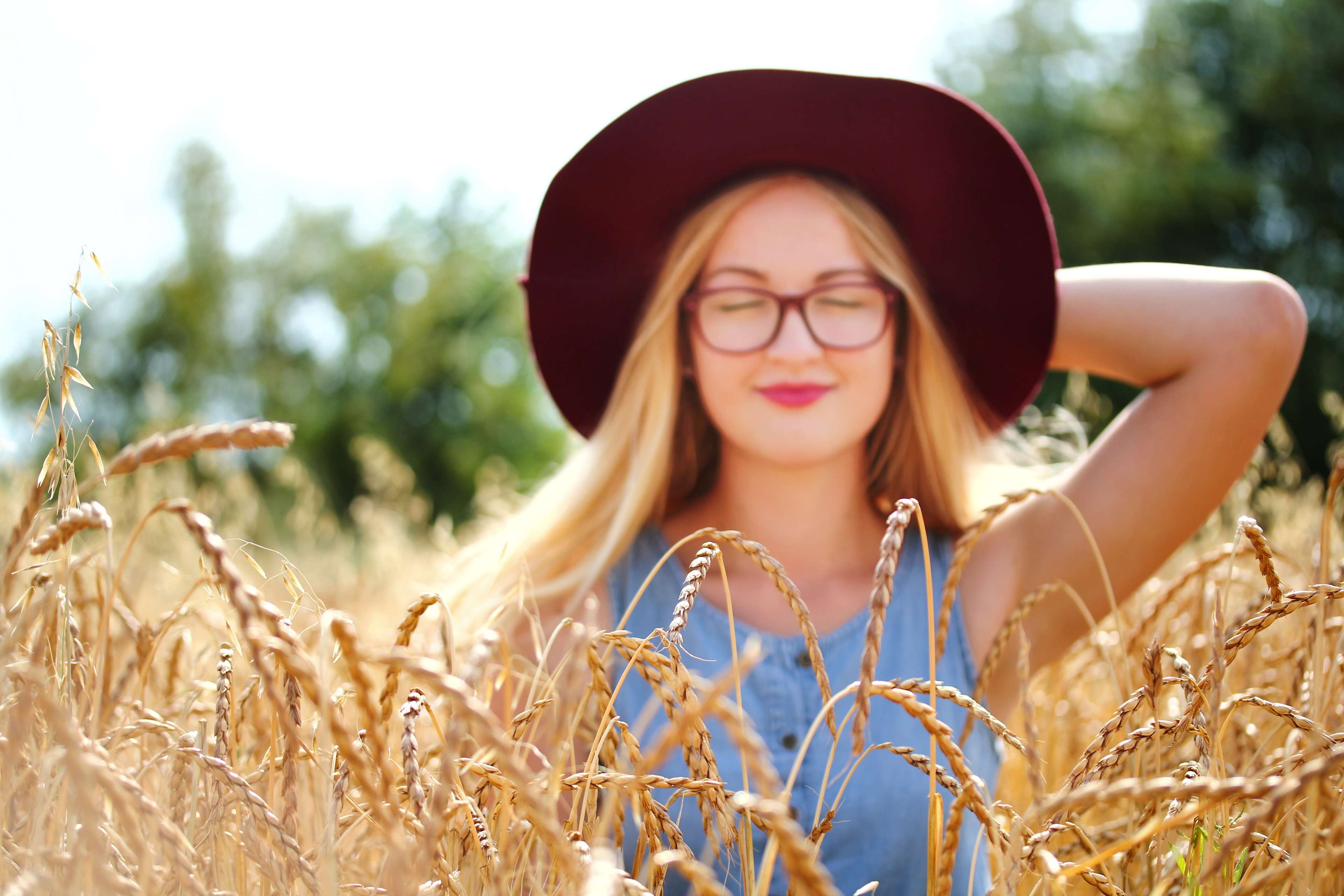 Woman with glasses and hat in wheat field 4K HD Wallpaper