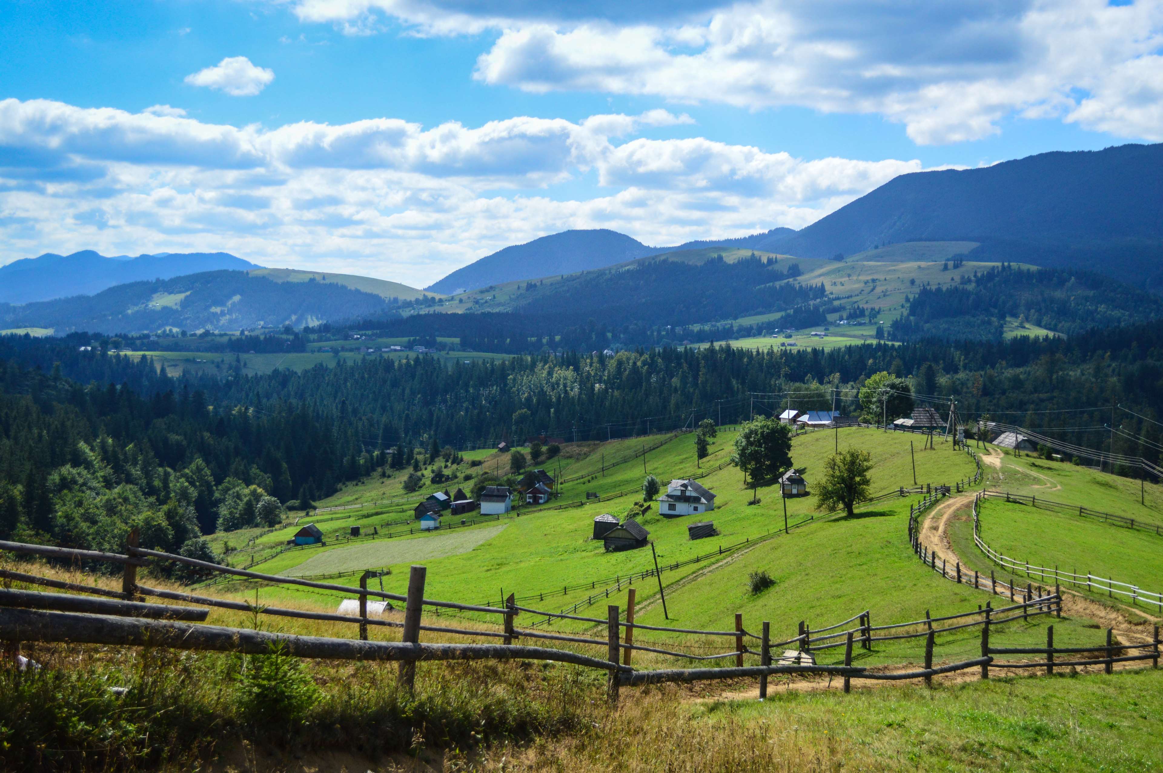 Summer hills and mountains with houses and fences 4K HD Wallpaper
