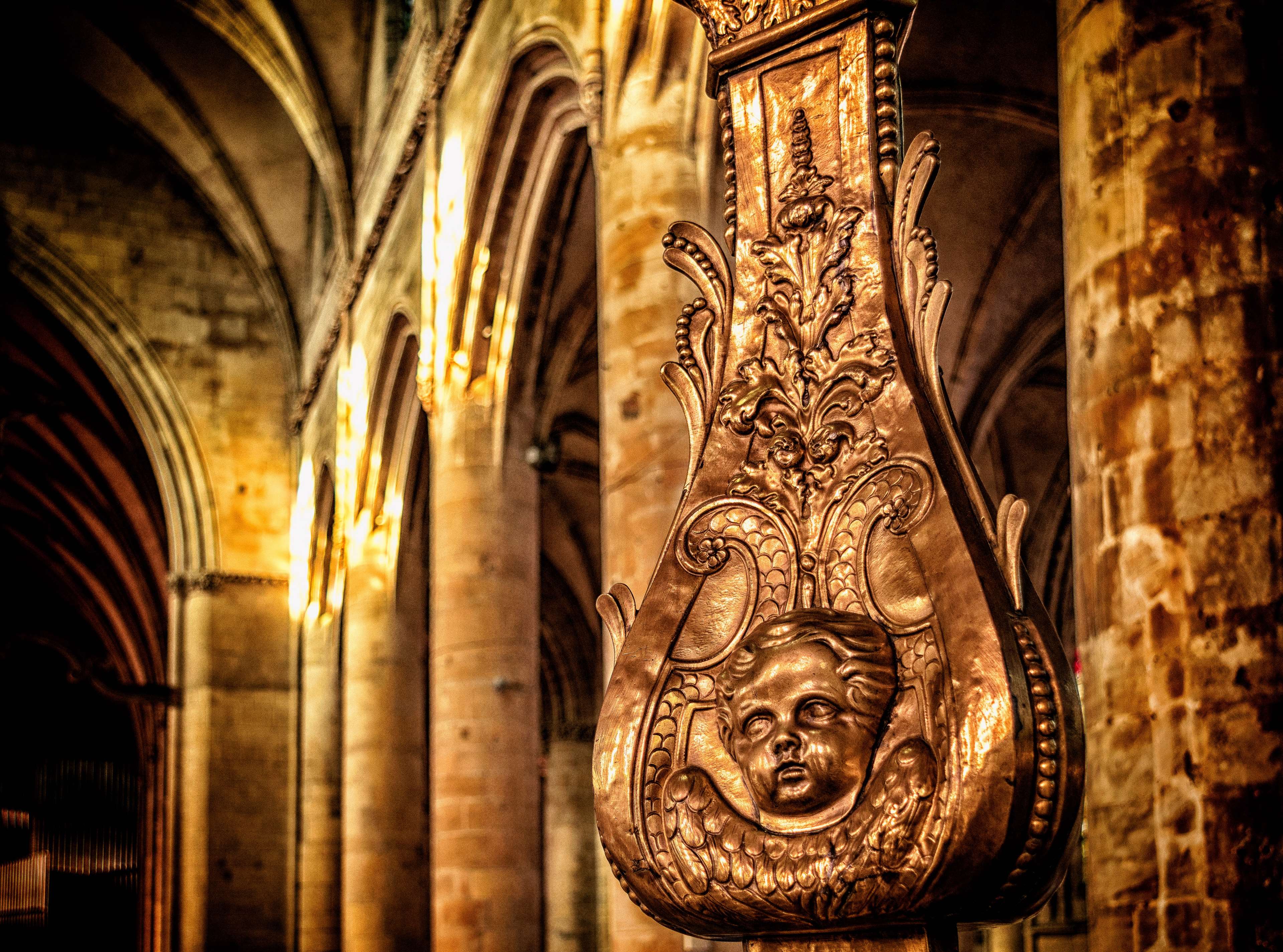 Ornate golden sculpture with angel face in church HD Wallpaper