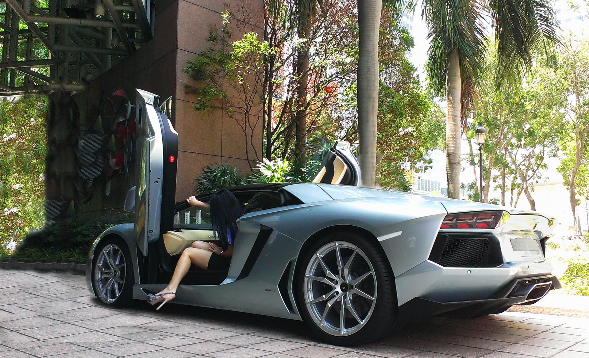Woman getting into a silver Lamborghini Aventador HD Wallpaper