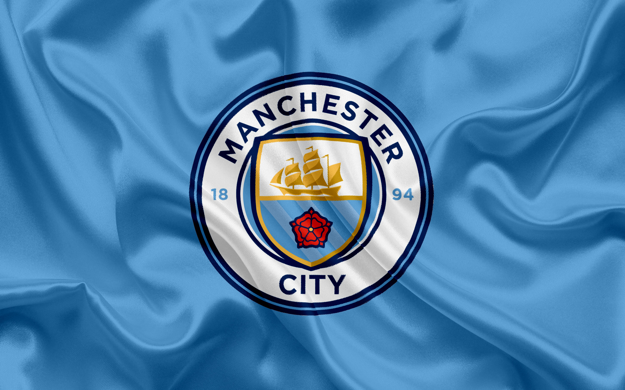 Manchester City F.C. Logo on Blue Fabric HD Wallpaper