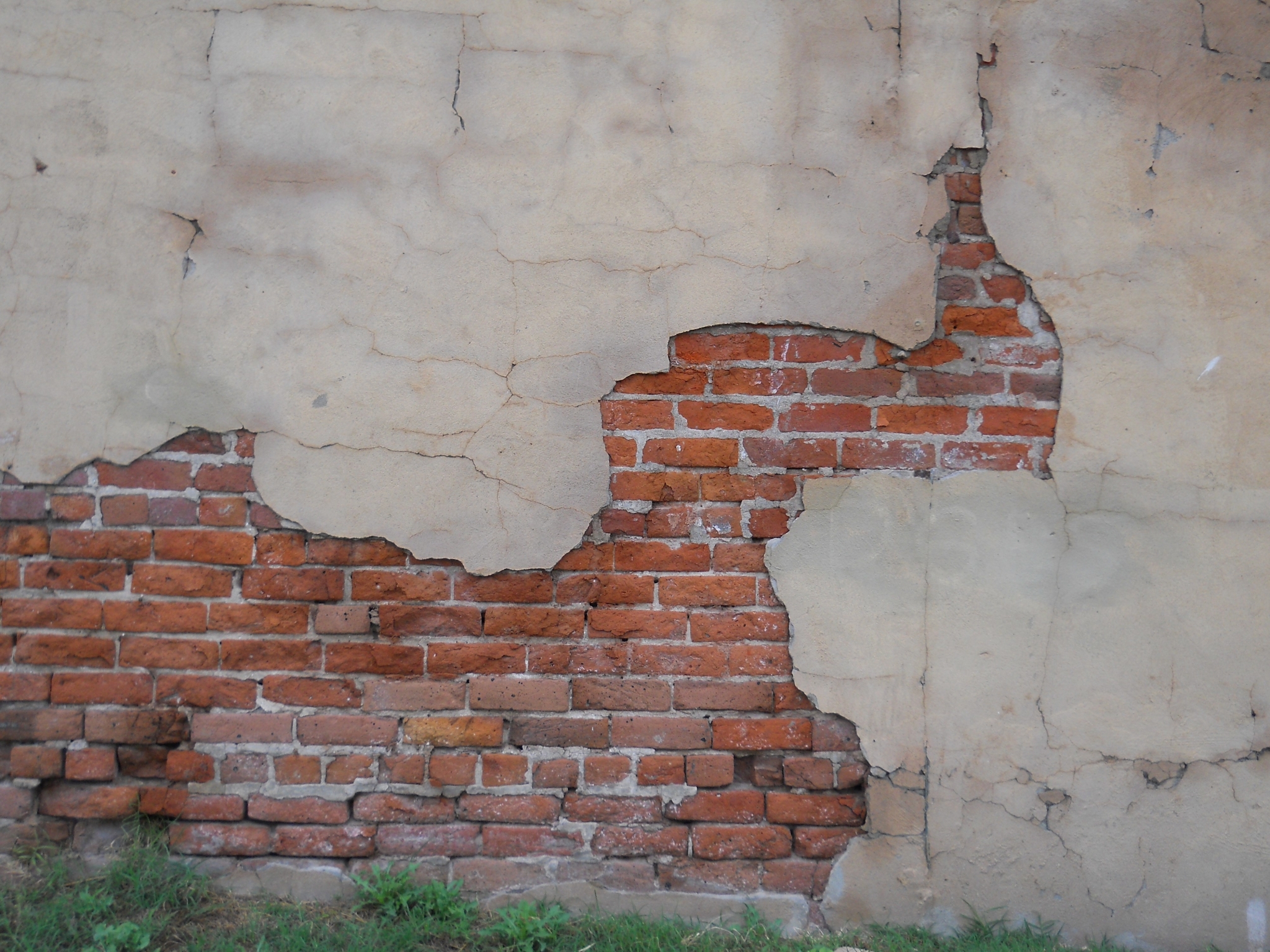 Damaged brick wall with peeling plaster HD Wallpaper