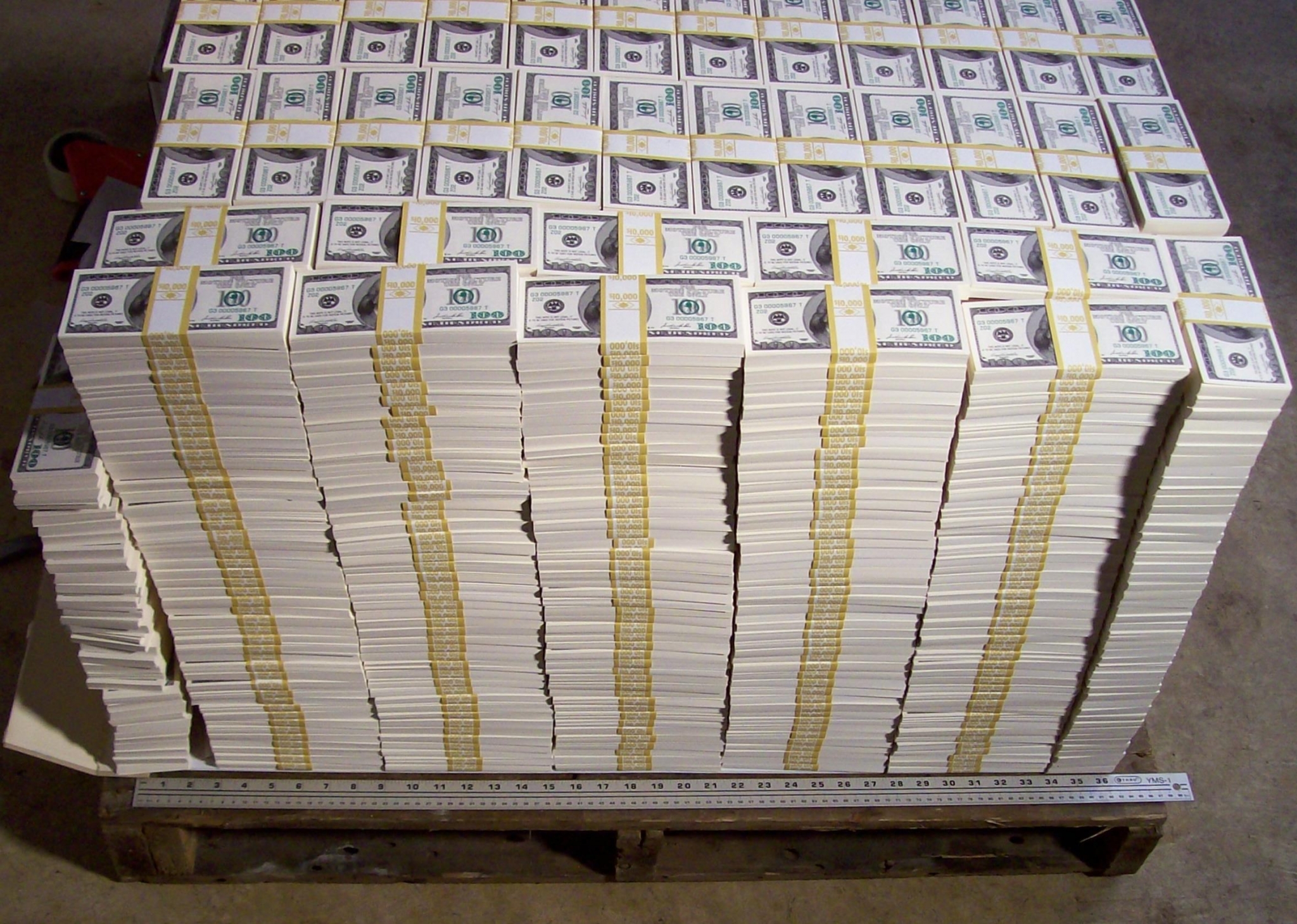 Stacks of fake $100 bills on a pallet HD Wallpaper