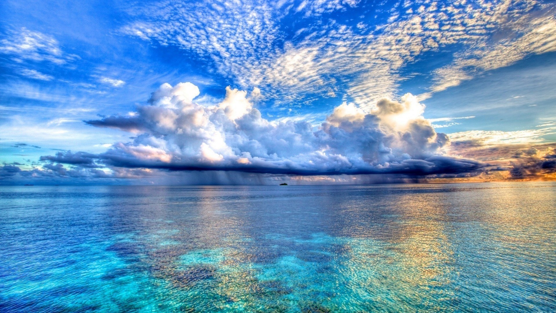 Ocean with dramatic clouds and distant island HD Wallpaper
