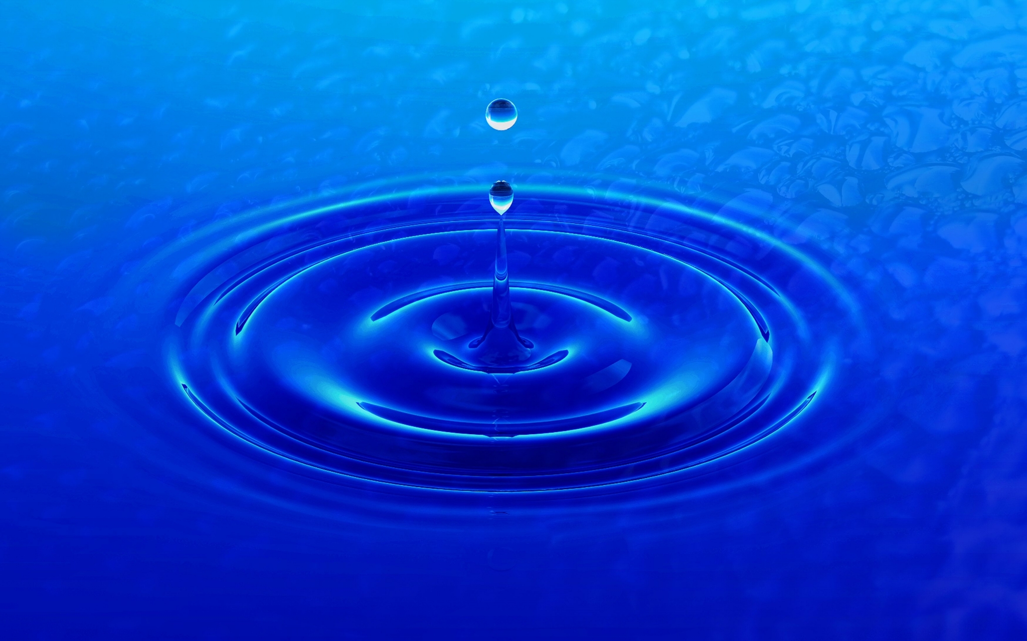 Water drop creating ripples on blue surface HD Wallpaper