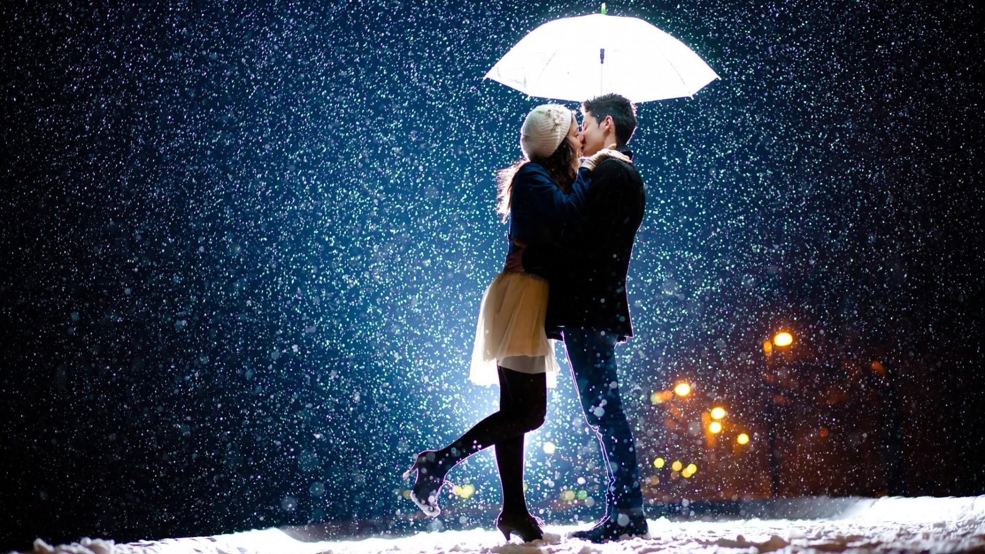 Couple kissing under umbrella in snow HD Wallpaper