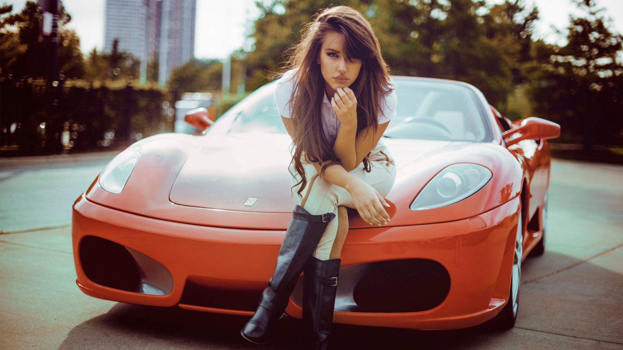Woman sitting on a red Ferrari HD Wallpaper