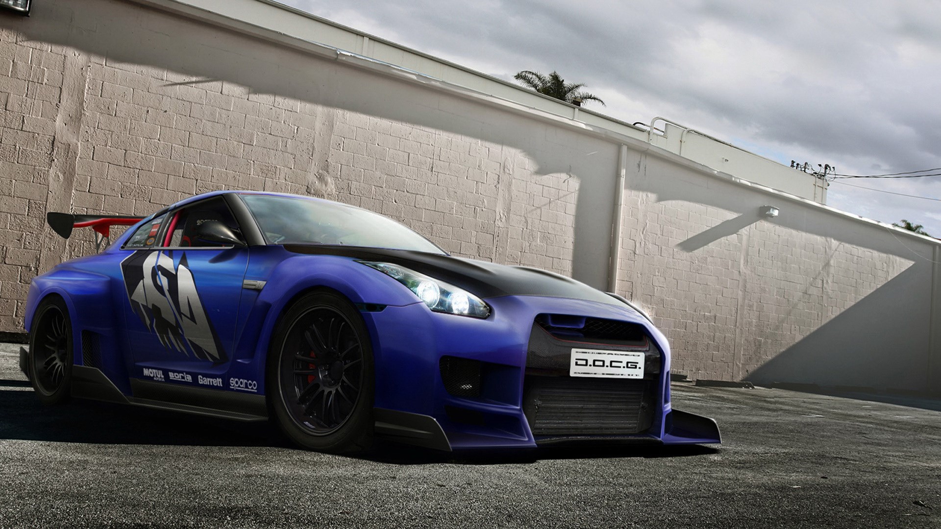 Blue Nissan GT-R with racing decals HD Wallpaper