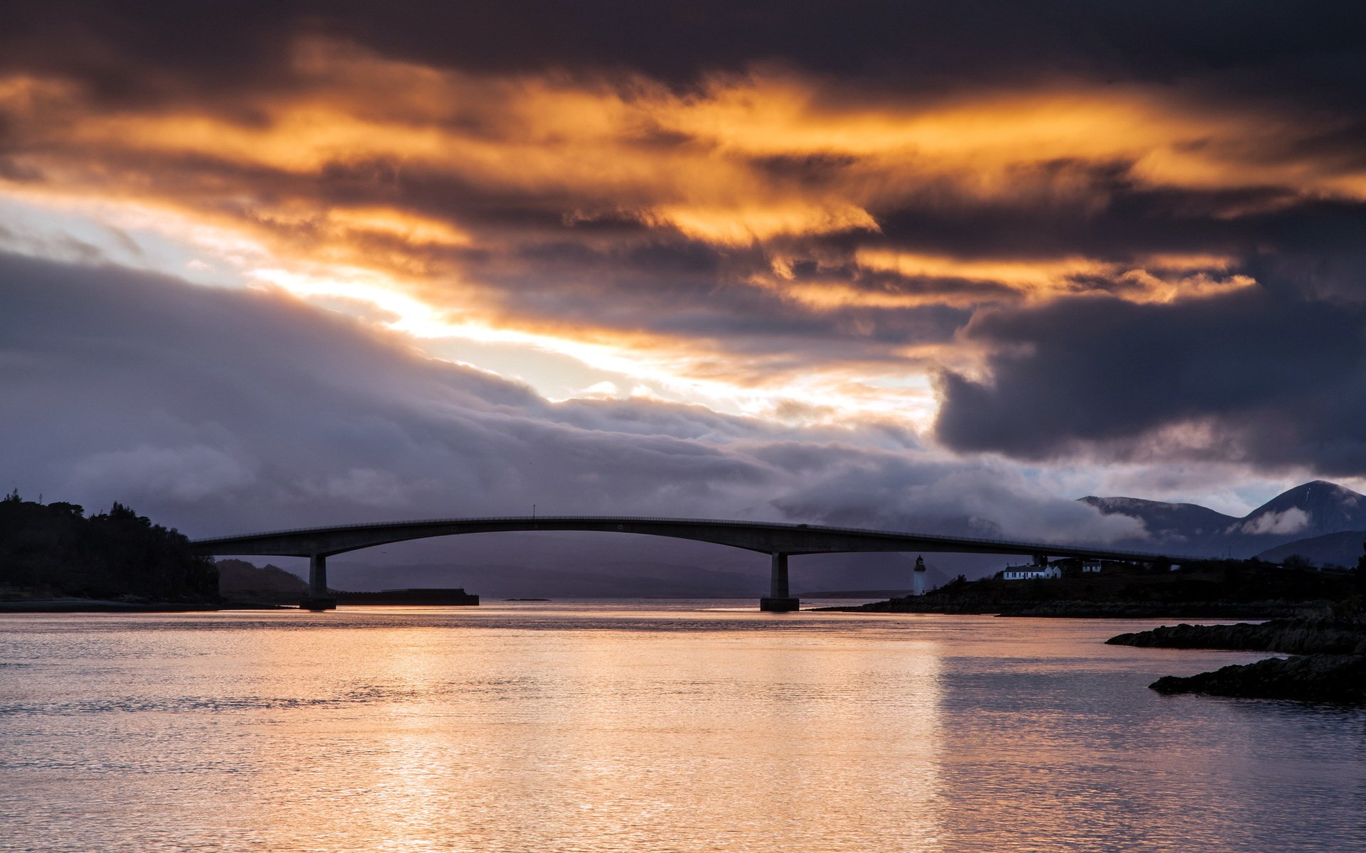 Bridge over water at sunset with dramatic clouds HD Wallpaper