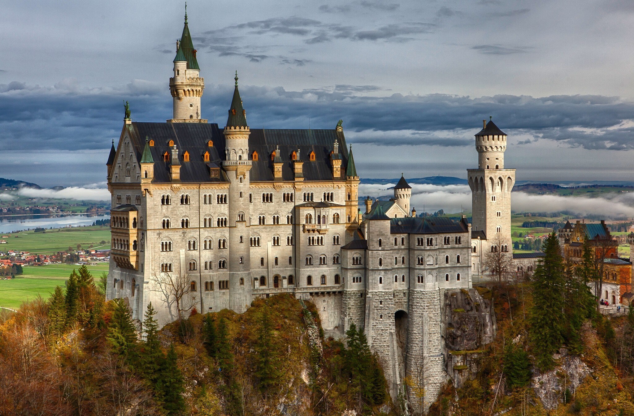 Neuschwanstein Castle on a hill with clouds HD Wallpaper