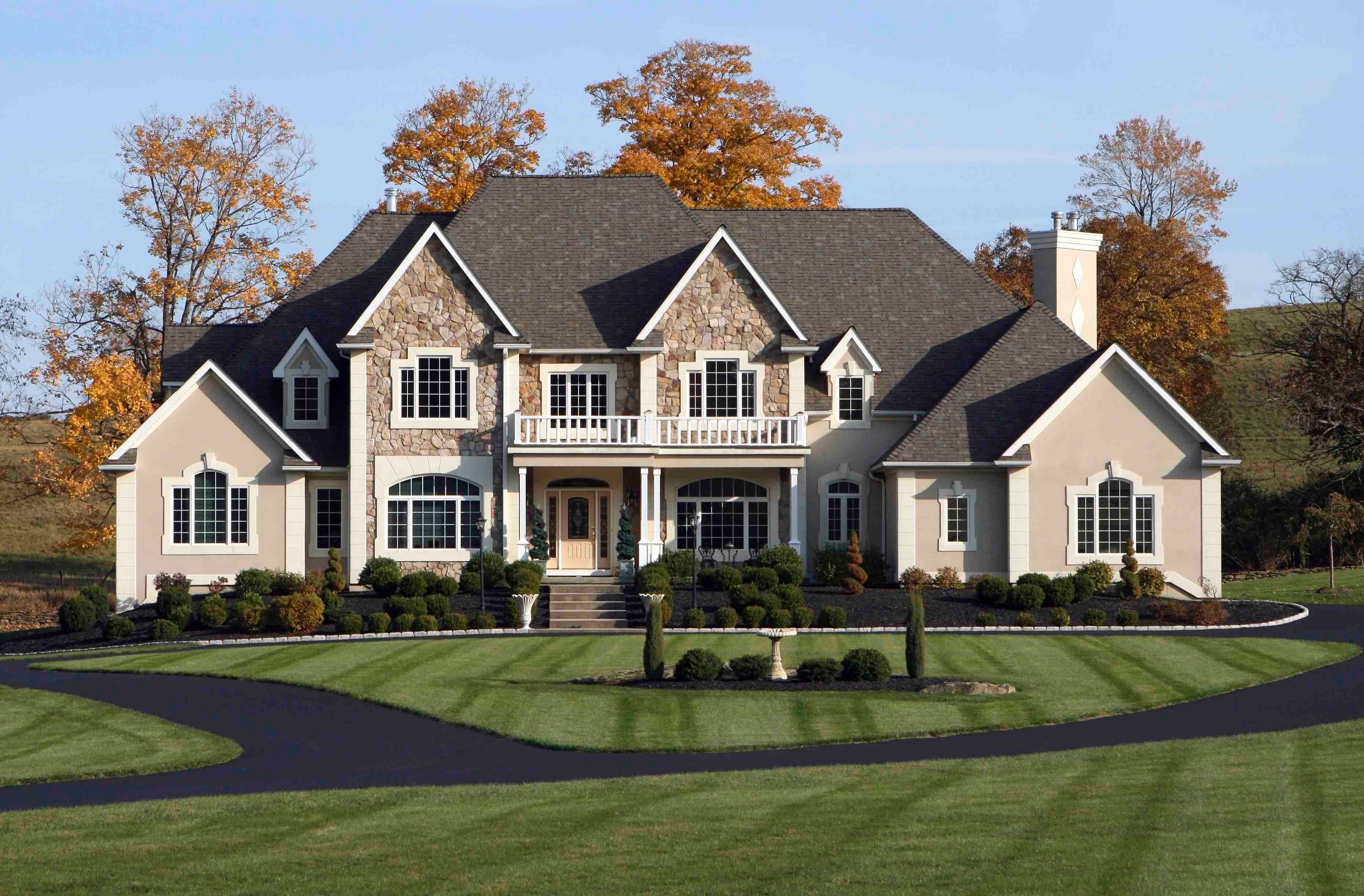 Large stone and stucco house with manicured lawn HD Wallpaper