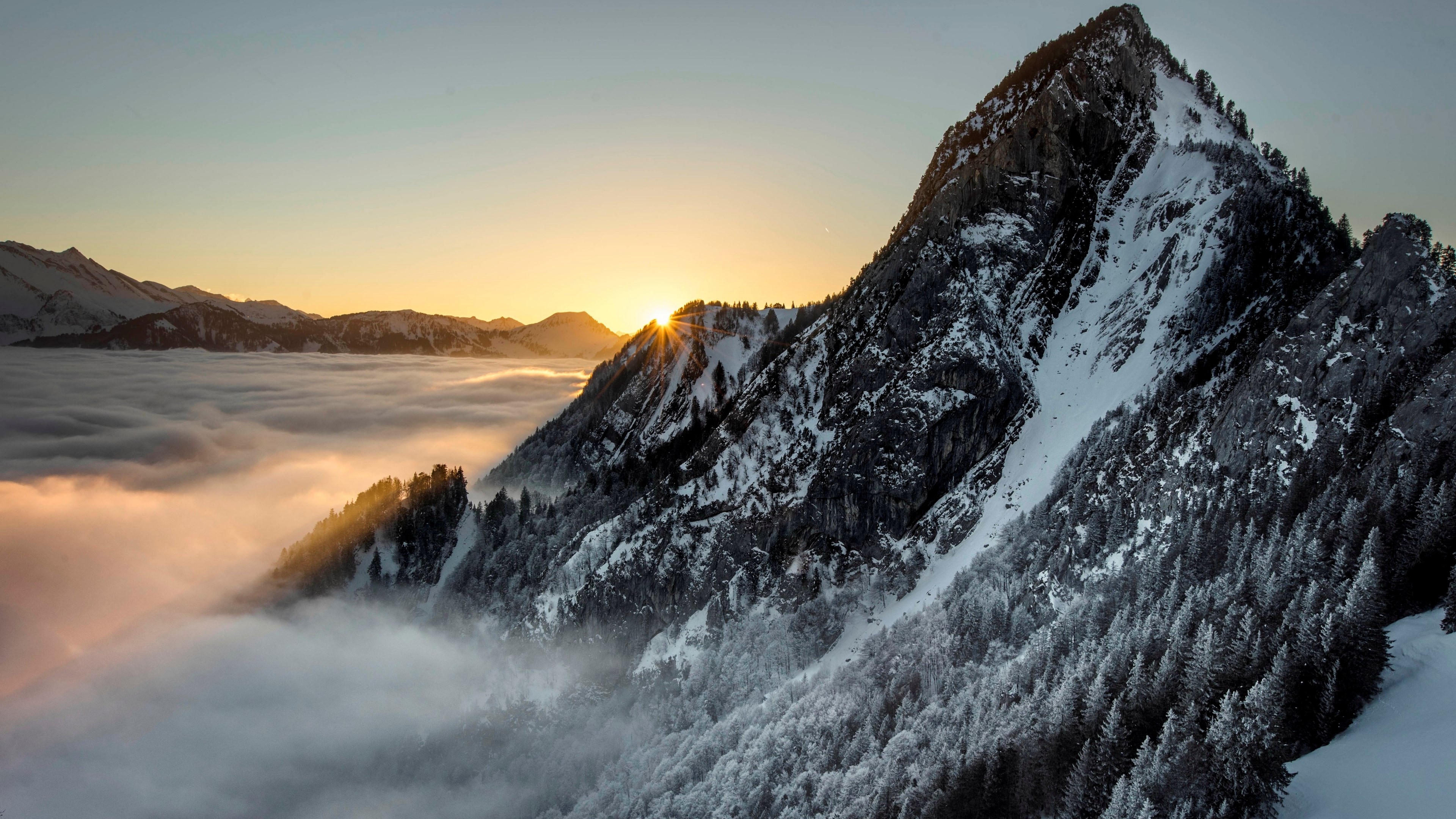 Mountain peak above clouds at sunrise 4K HD Wallpaper