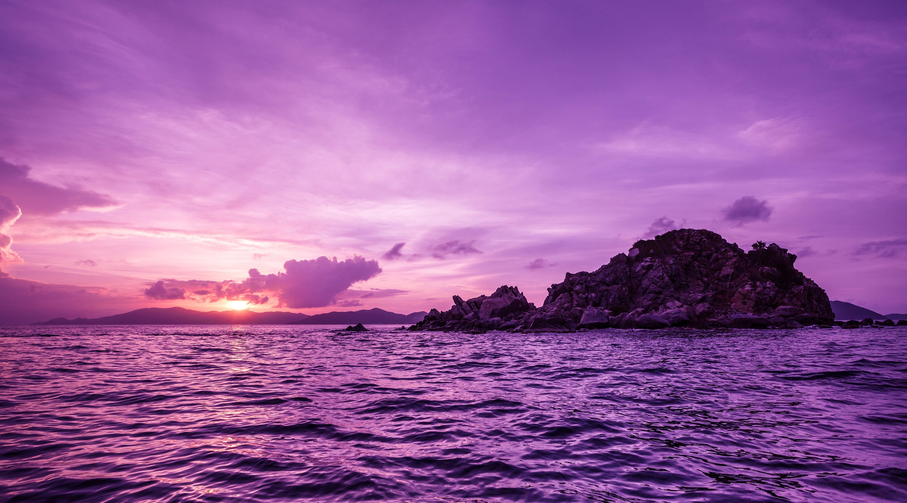 Purple sunset over ocean with rocky island HD Wallpaper