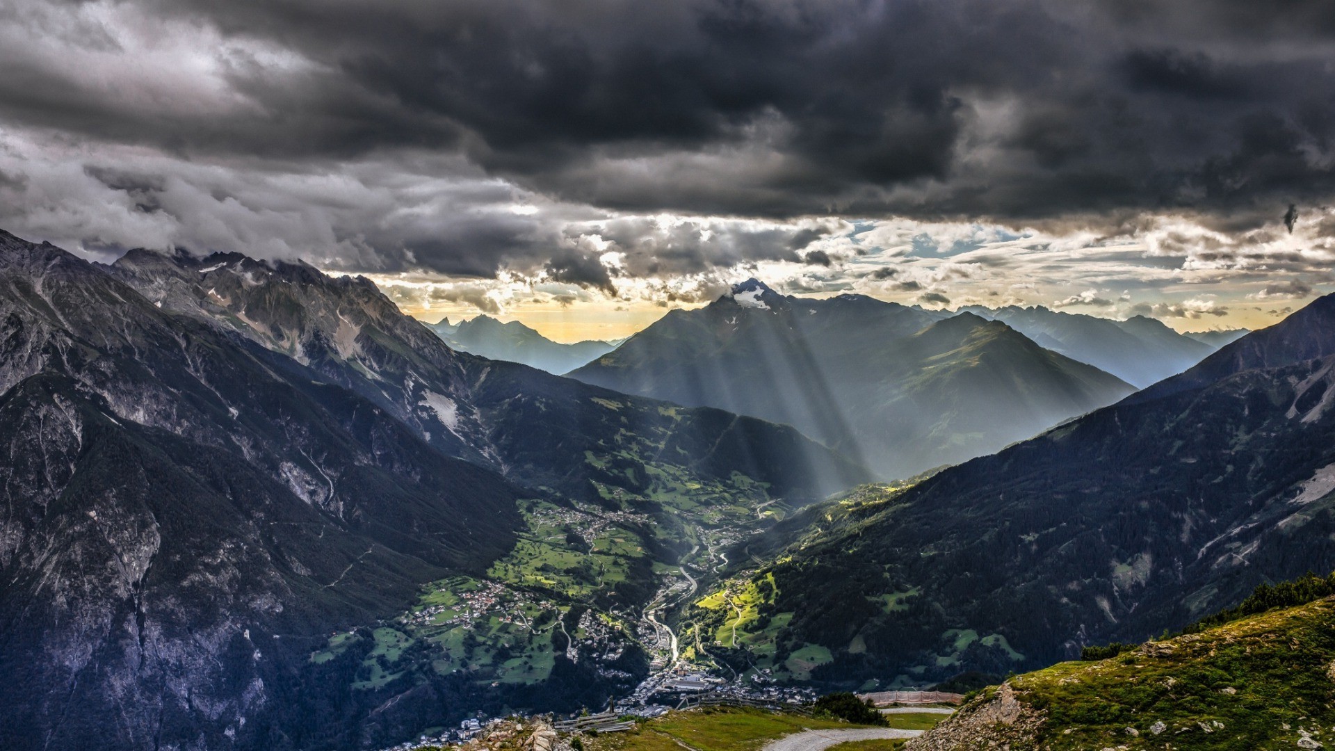 Sunlight Piercing Through Clouds over Austrian Alps Valley HD Wallpaper