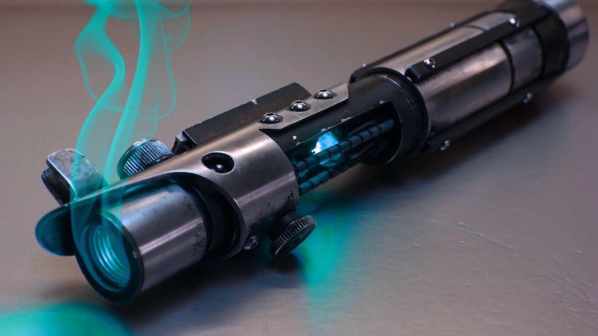 Star Wars lightsaber with blue glowing core and green smoke HD Wallpaper