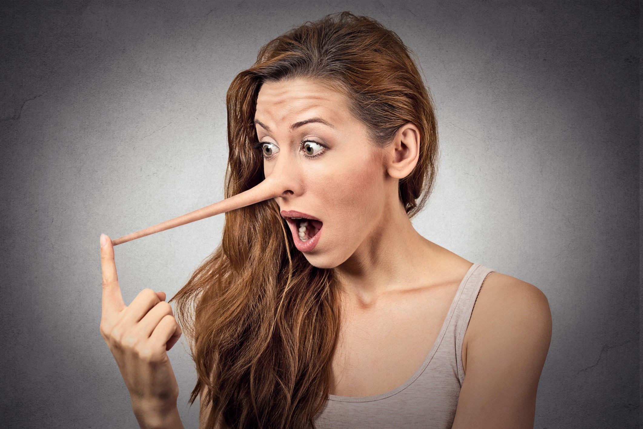 Woman with Pinocchio nose touching it HD Wallpaper