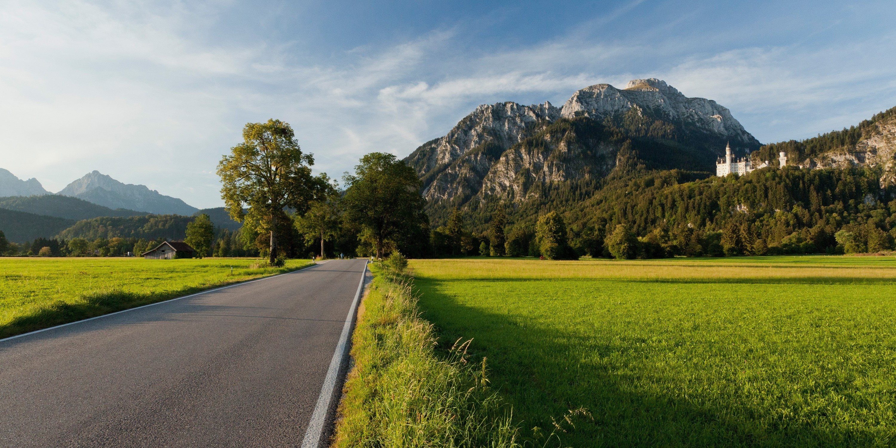 Road leading to mountains with a castle HD Wallpaper