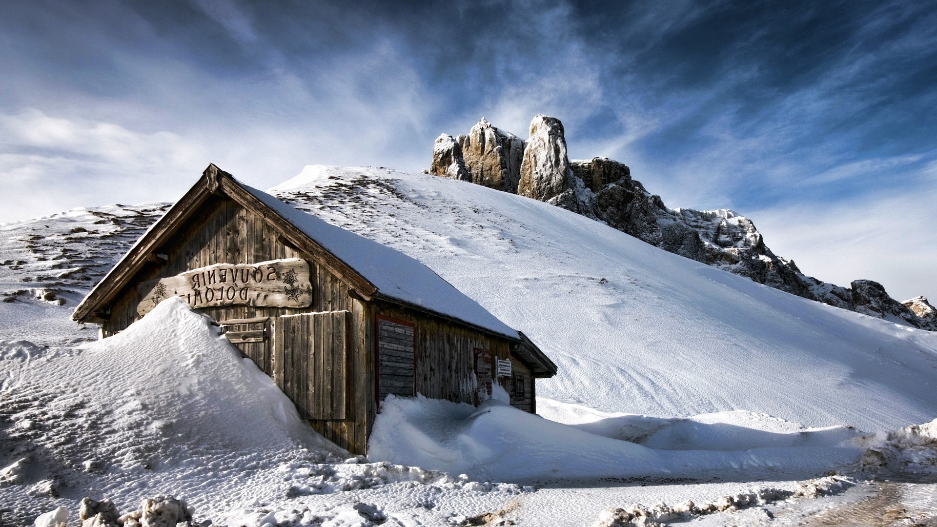 Wooden house in snow with Dolomites mountains HD Wallpaper