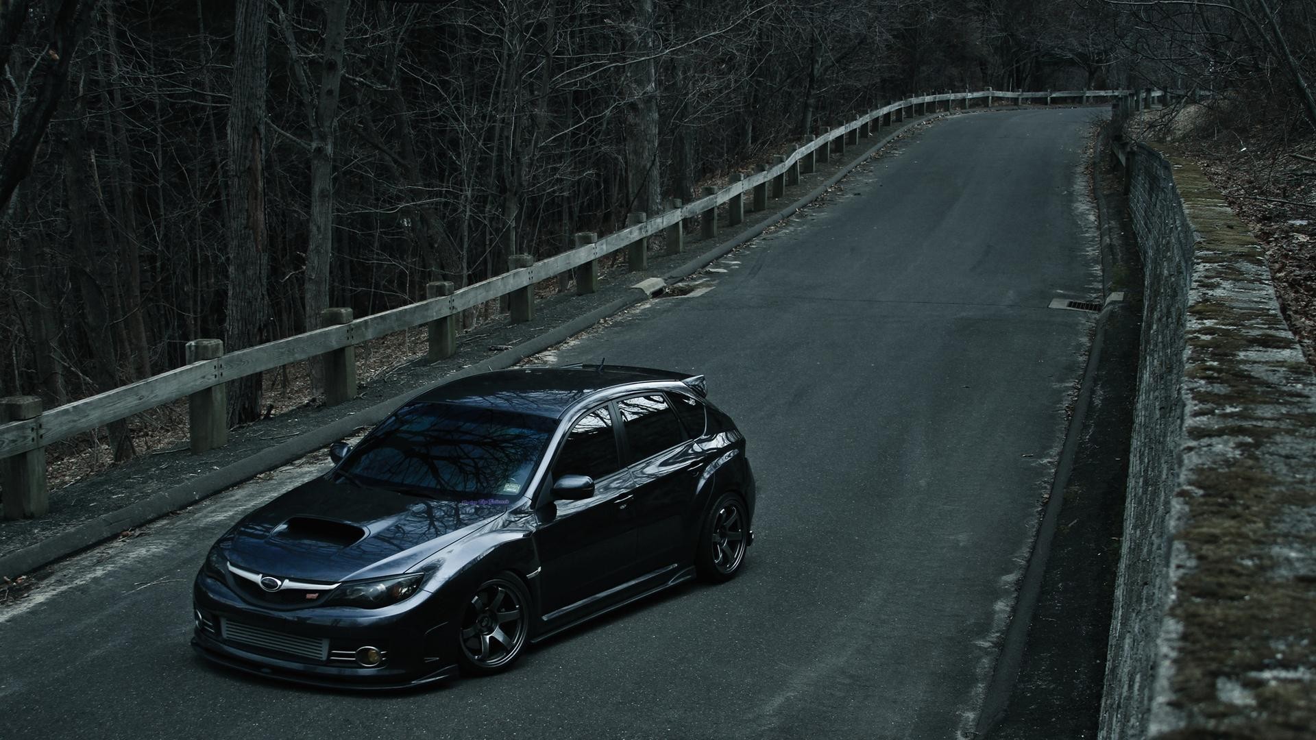 Dark Subaru Impreza WRX STI on a Winding Road HD Wallpaper