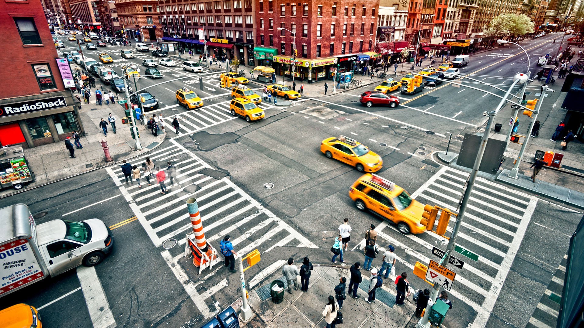 New York City street with yellow taxis and pedestrians HD Wallpaper