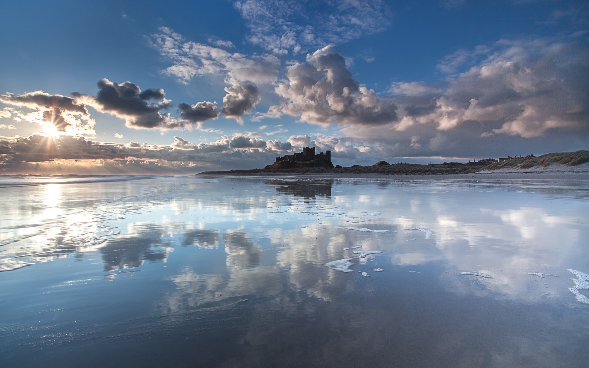 Bamburgh Castle reflected on a wet beach at sunset HD Wallpaper
