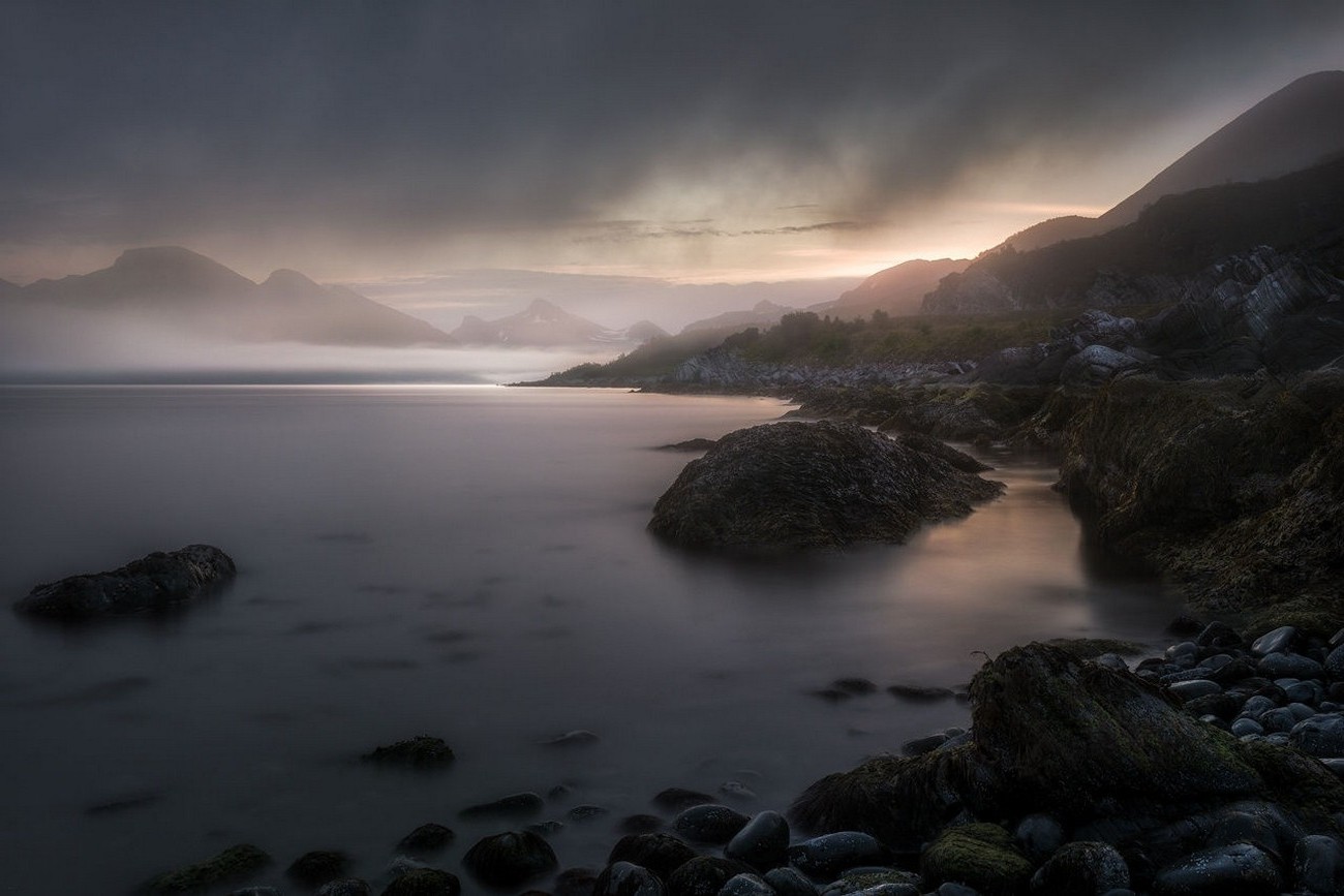 Misty mountains and rocky coast at sunset HD Wallpaper