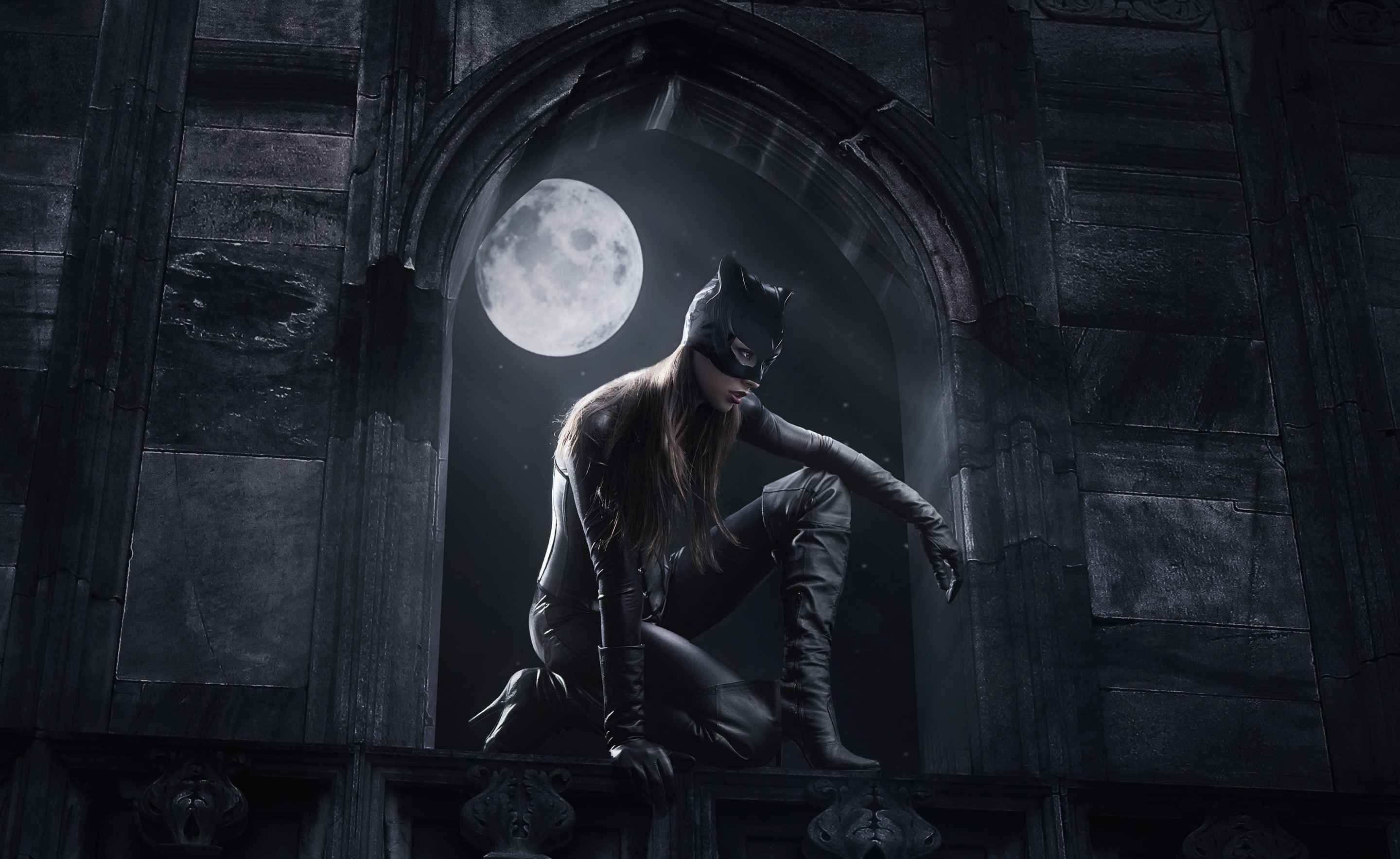 Catwoman crouching on a ledge under the moon HD Wallpaper