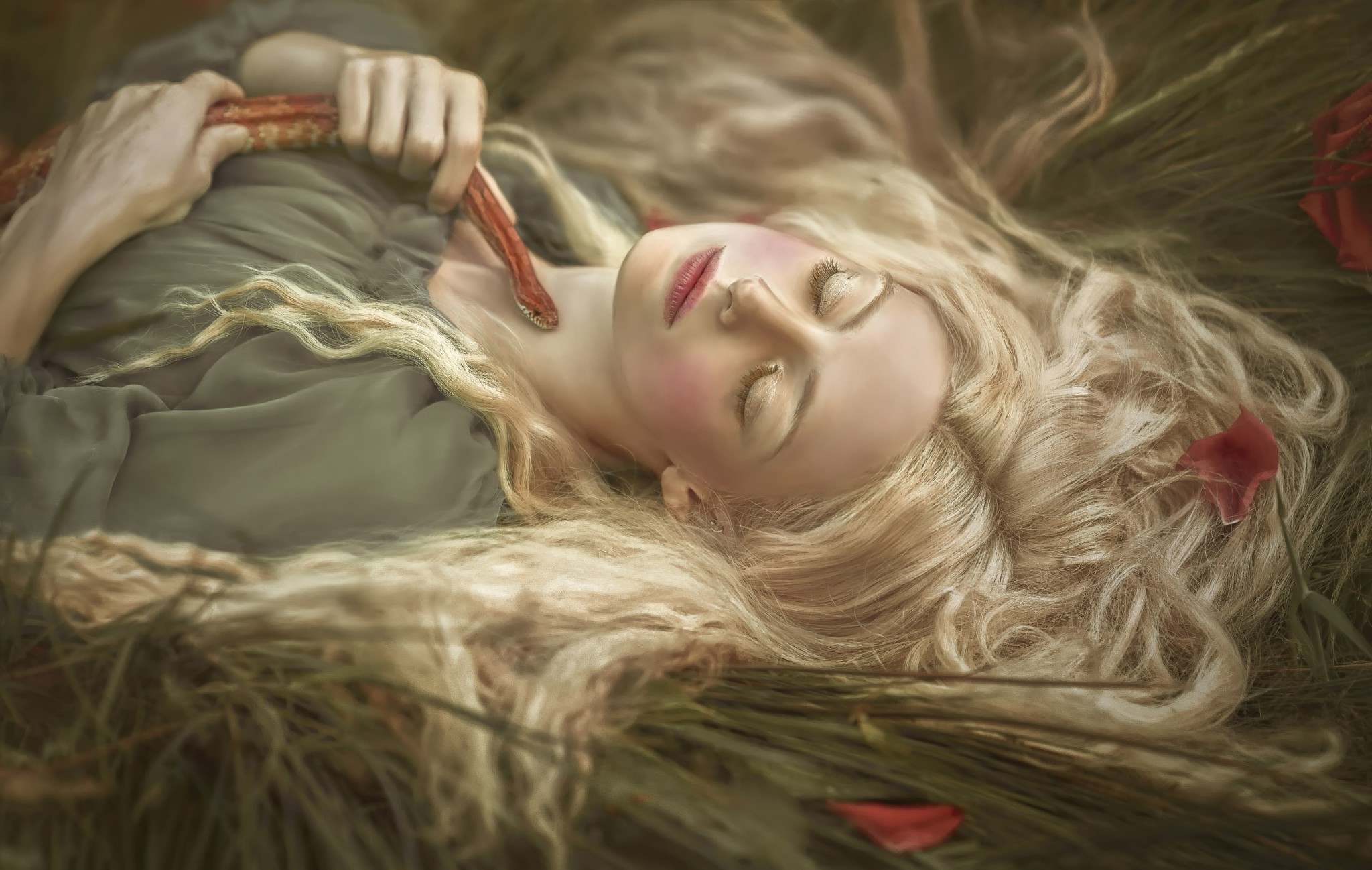 Woman with snake in grass HD Wallpaper