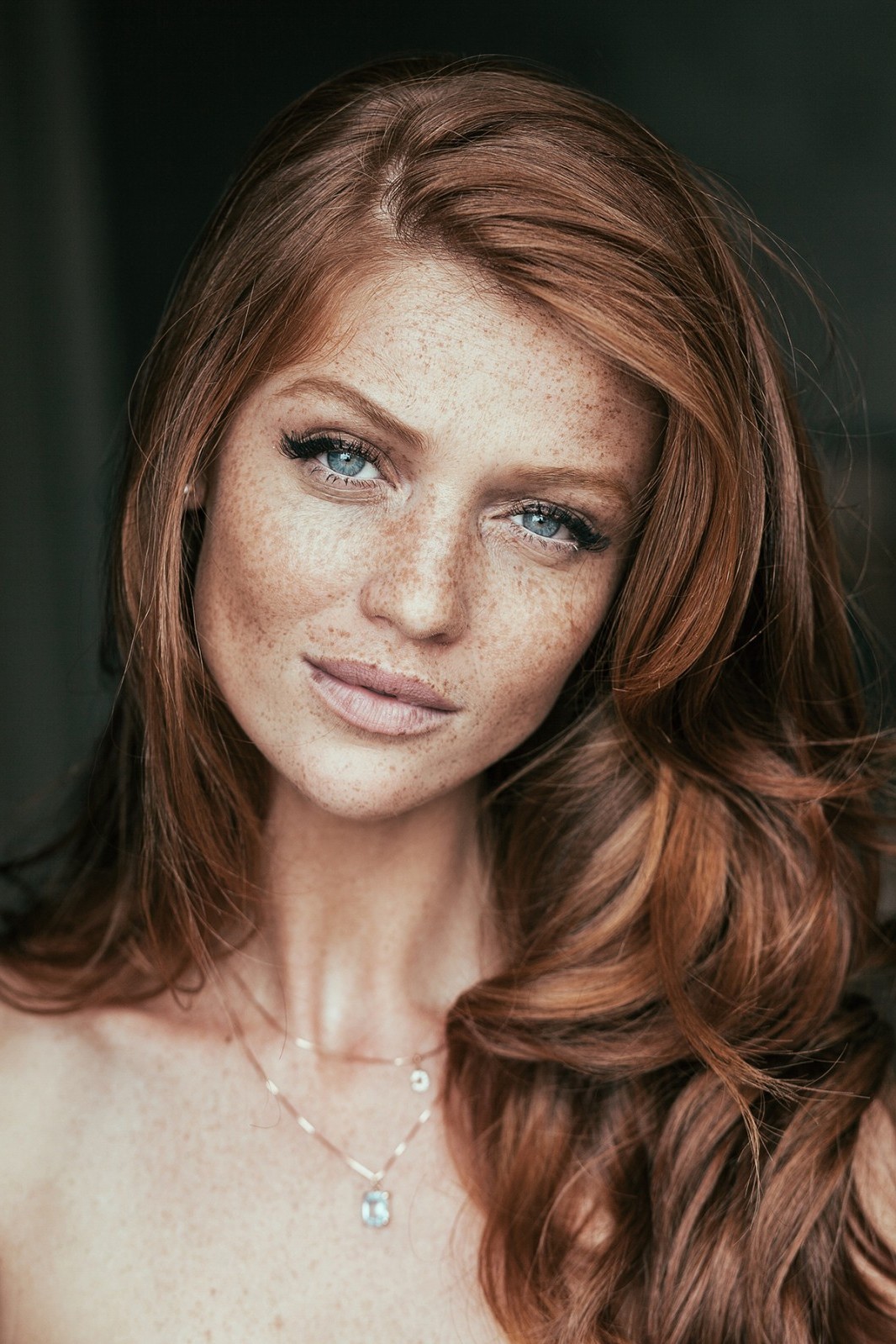 Redhead model with freckles looking at viewer HD Wallpaper
