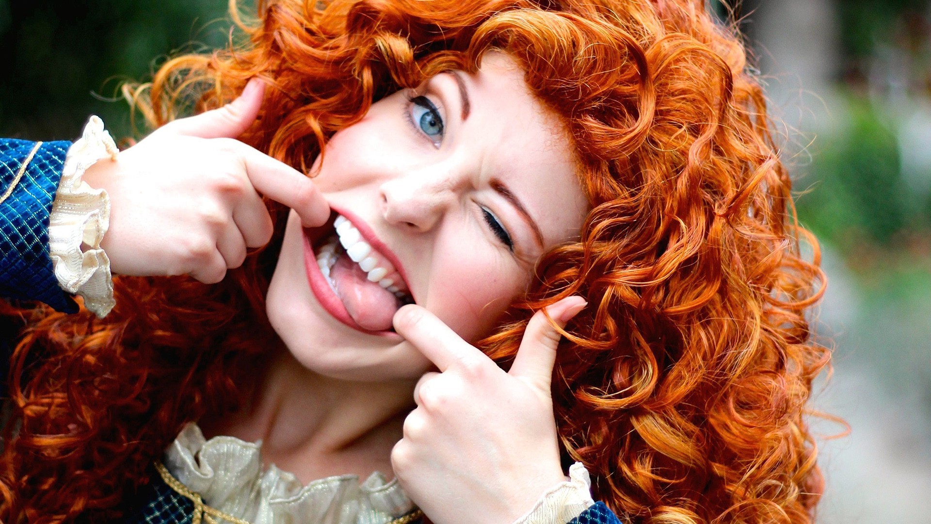 Woman with red curly hair and blue eyes making a funny face HD Wallpaper