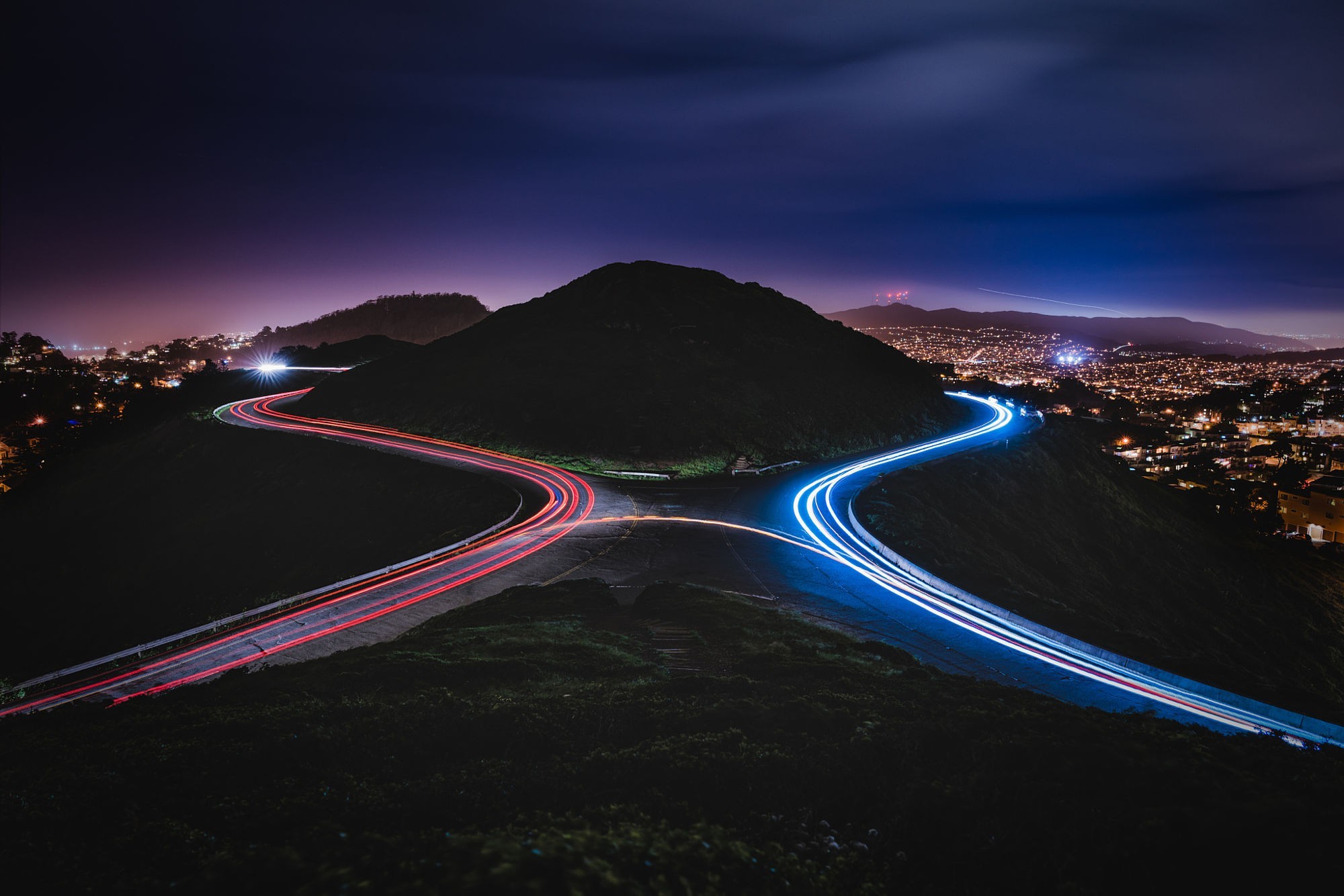 Roads with light trails at night over city HD Wallpaper